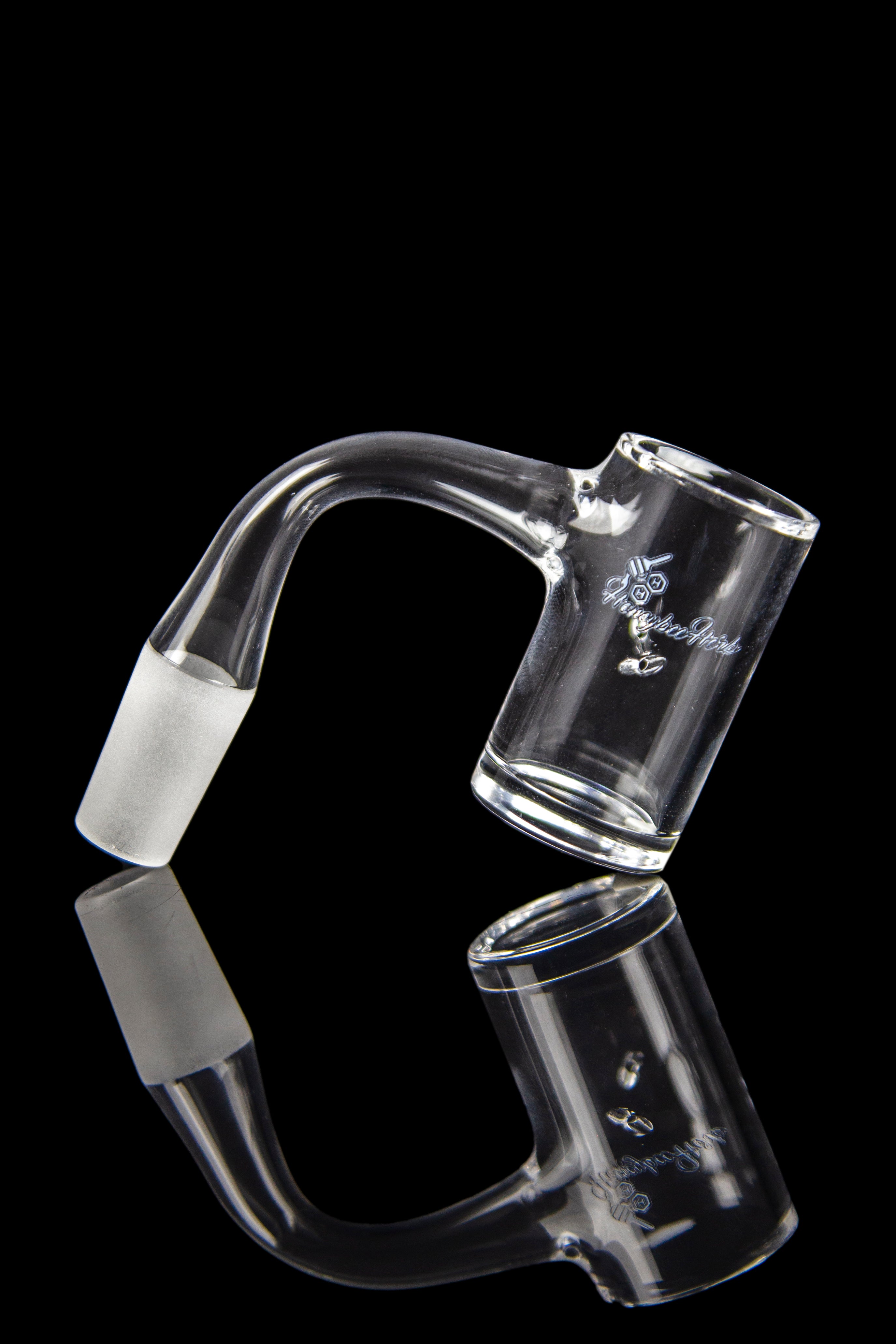 Clear glass oil rig with a curved mouthpiece and joint, reflected on a black surface.