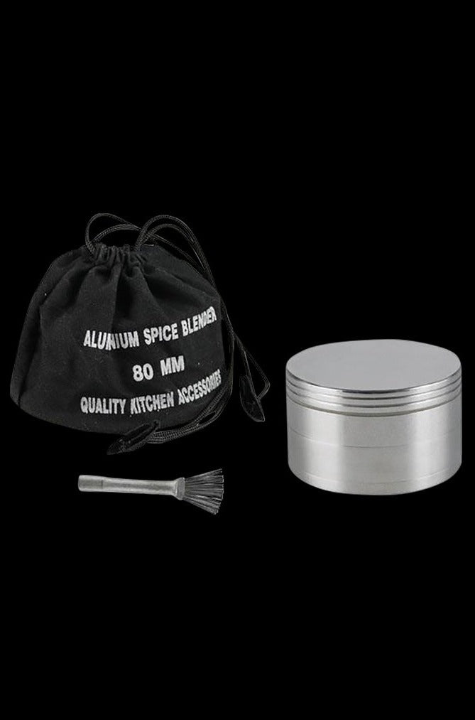 A close-up of the Metal 4-Piece Grinder, showcasing its silver metallic finish and cylindrical multi-tiered design.