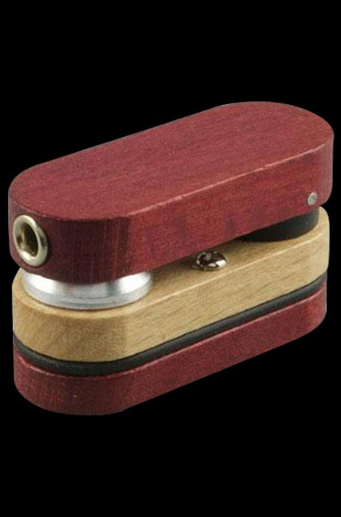 A close-up of the Twist-Out Simple Wood Pipe, showing its compact, wooden body and rounded mouthpiece against a dark backdrop.