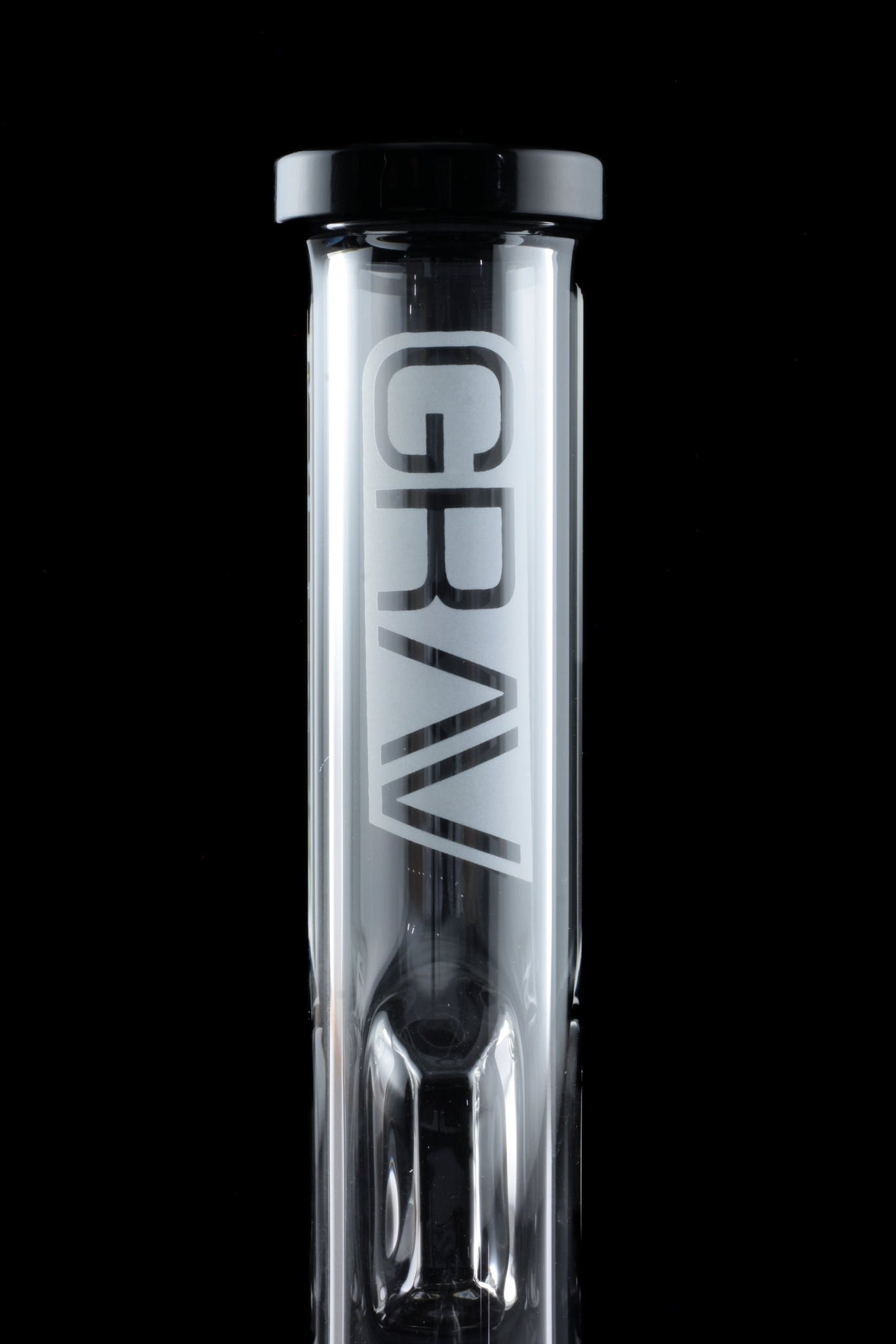 Clear glass bubbler with “GRAV” logo, illuminated against a black background.