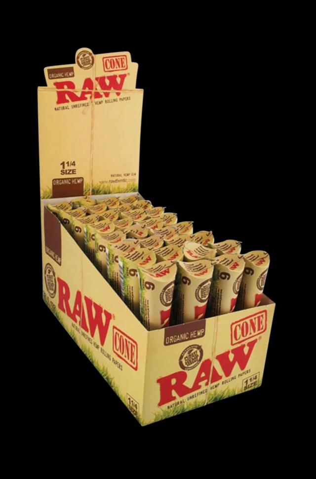 A stack of RAW Organic Hemp Raw 1 1/4" Prerolled Cones is displayed in a promotional box, angled slightly from above.