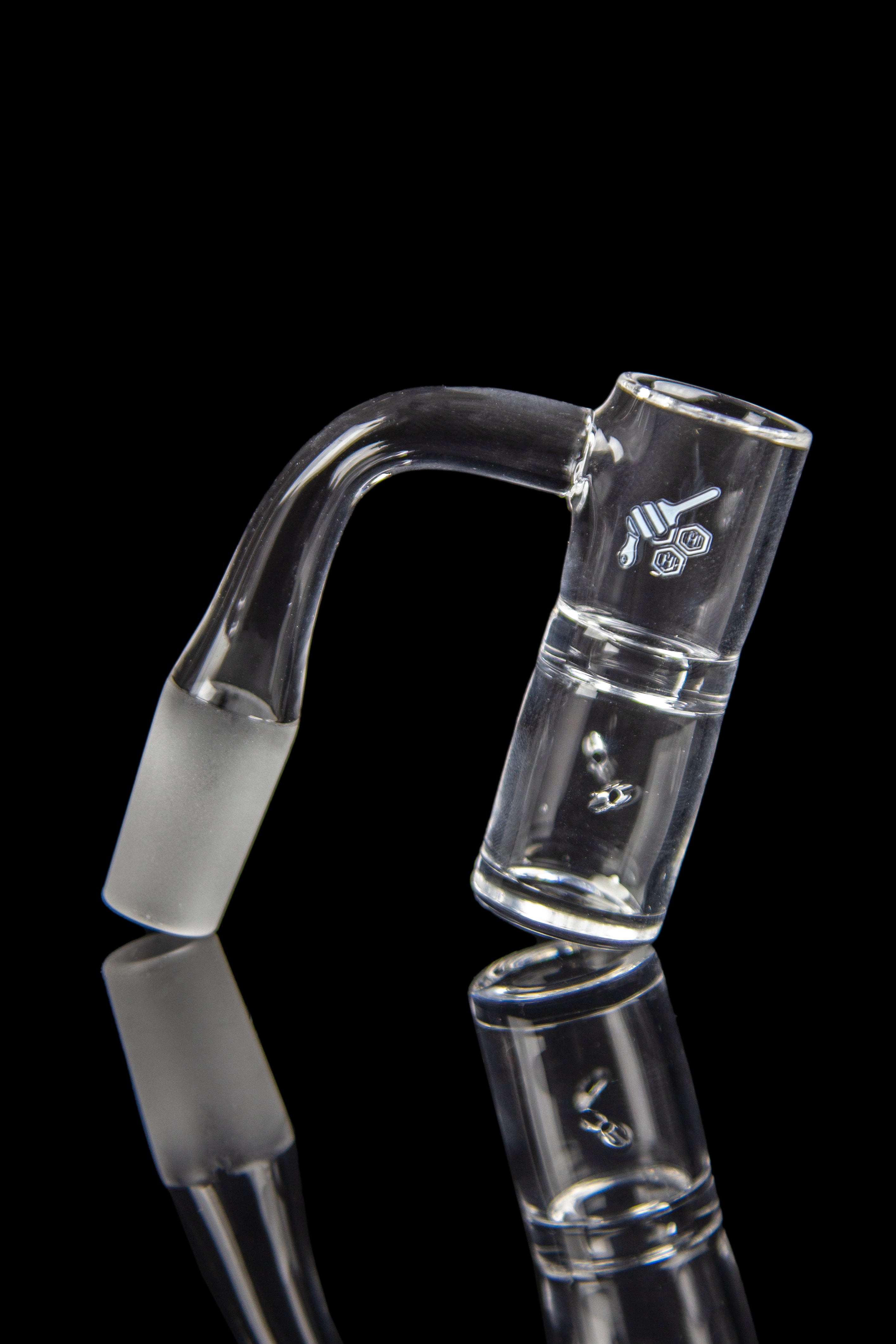 Clear glass bubbler with angled mouthpiece and logo, reflected on a black surface.