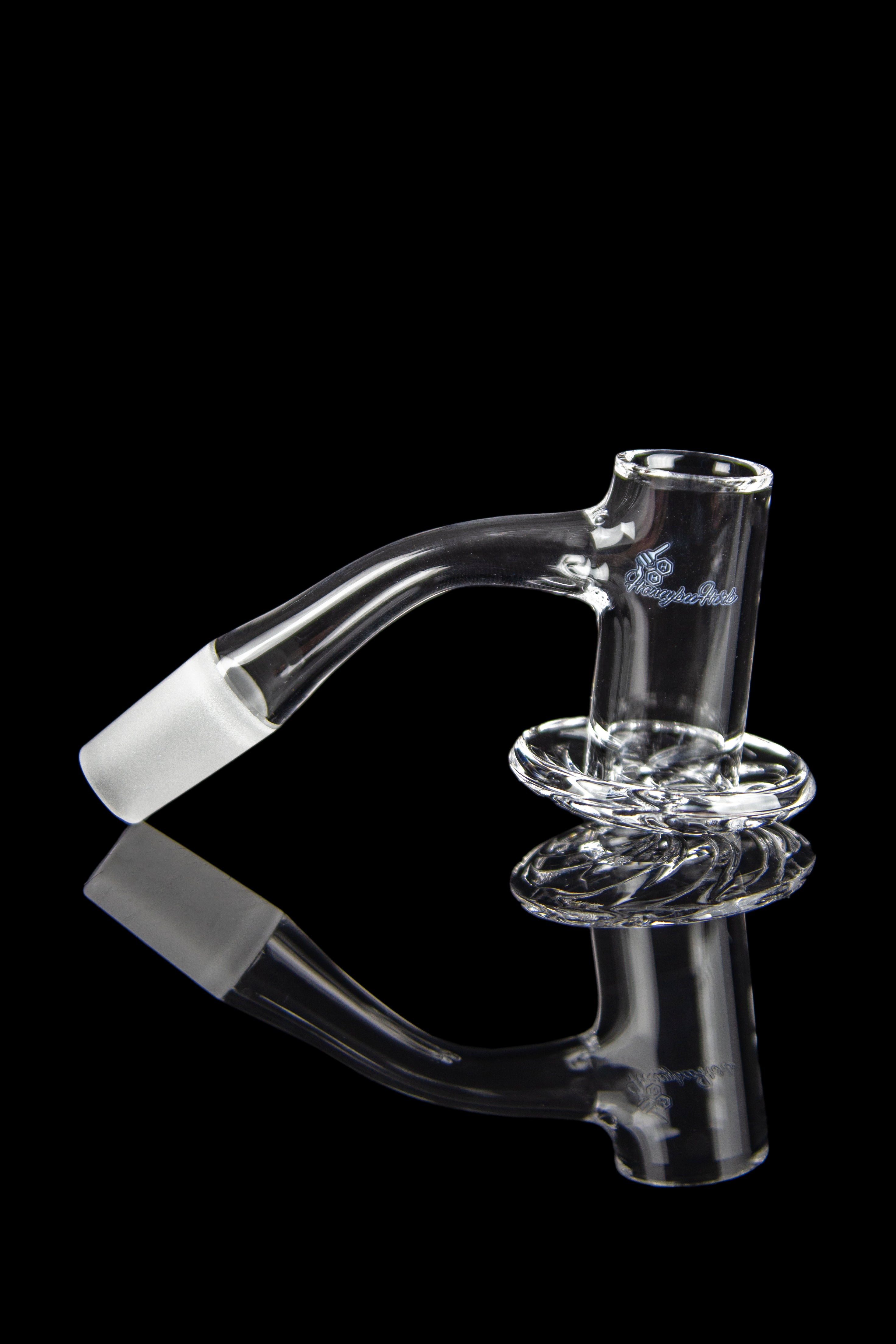 Clear glass cannabis oil rig with a curved neck and circular base, reflected on a black surface.