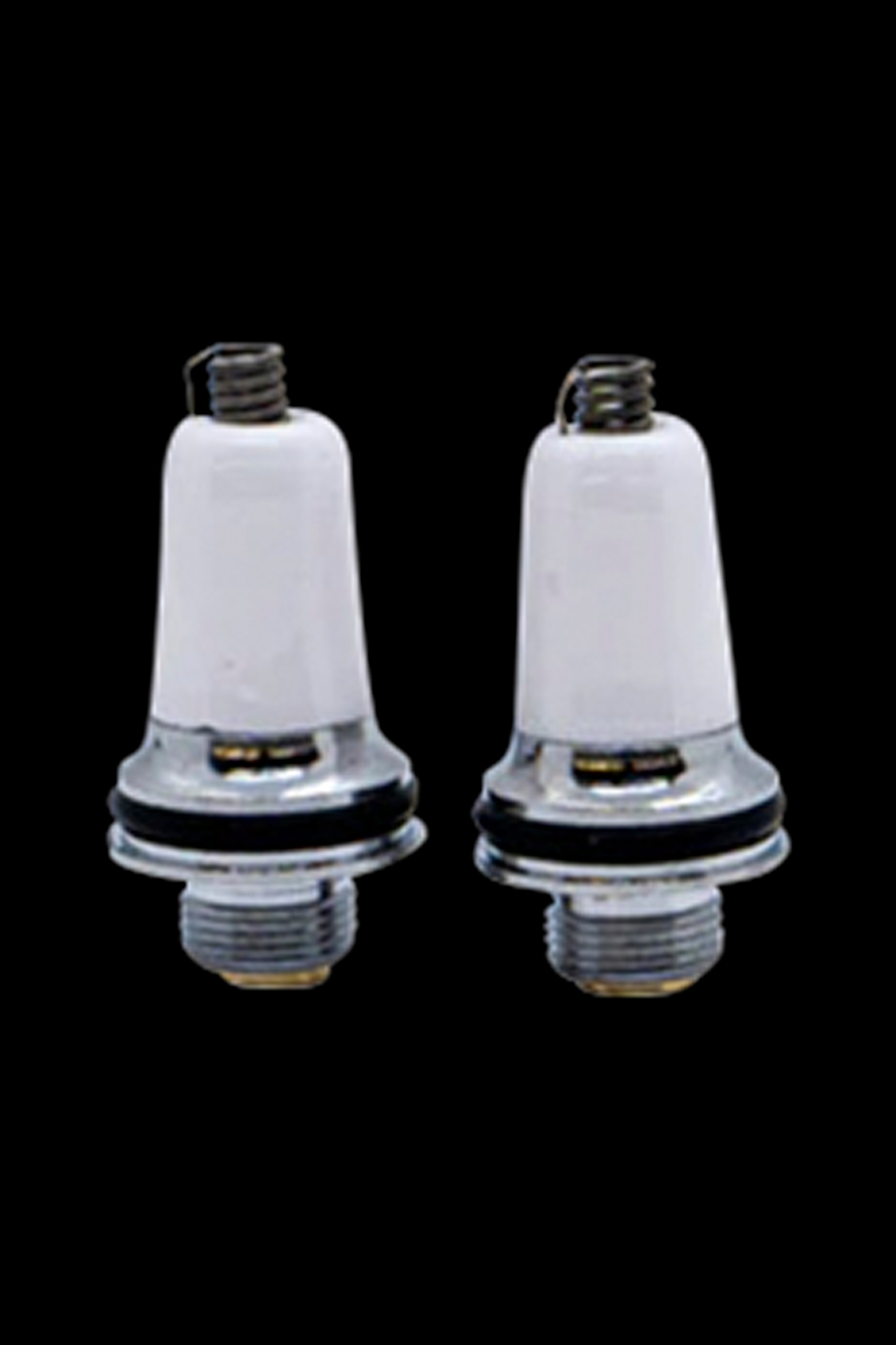 Two white ceramic cannabis oil cartridges with metal bases and mouthpieces against a black background.