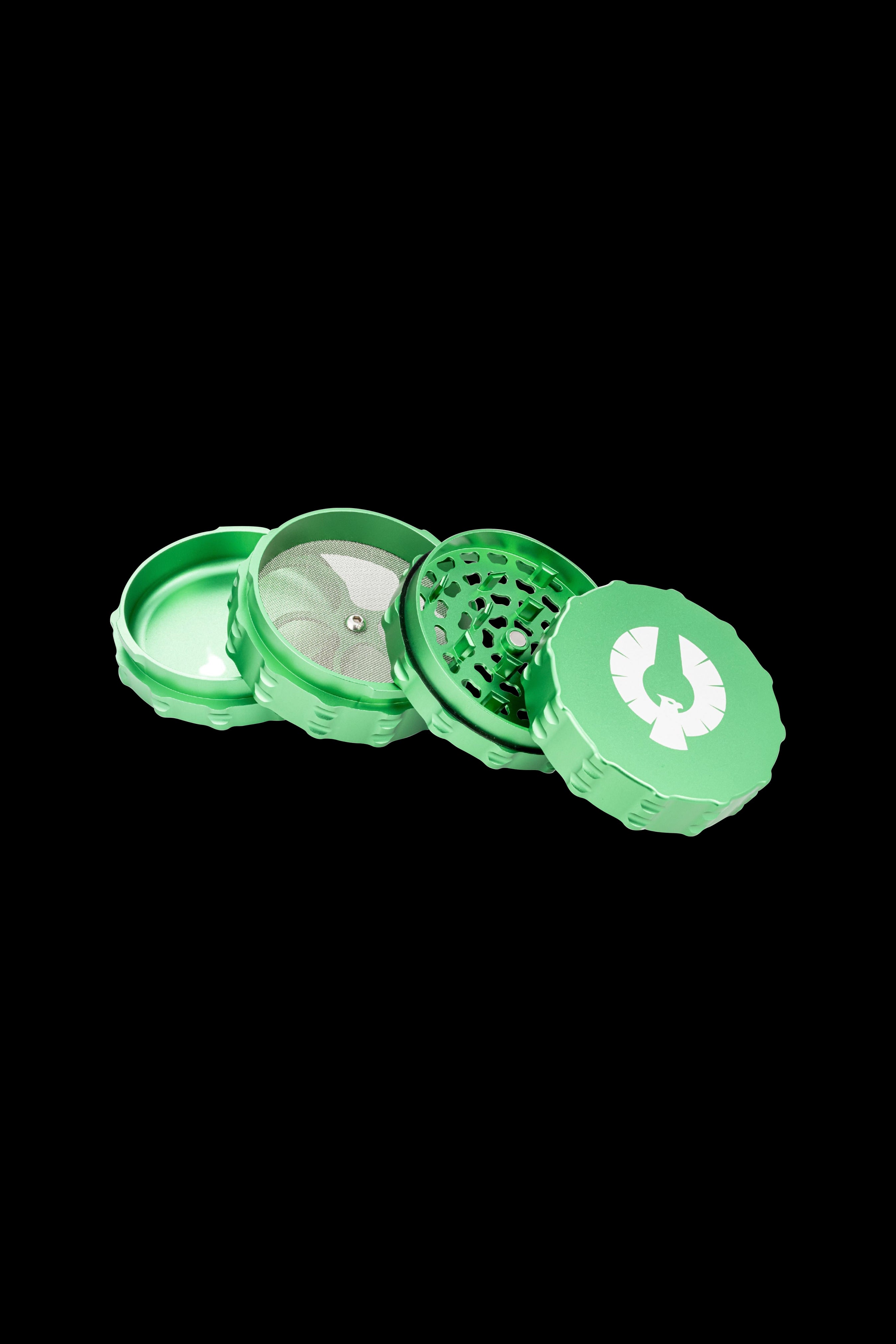 Green four-piece cannabis grinder with mesh screen and patterned top piece.