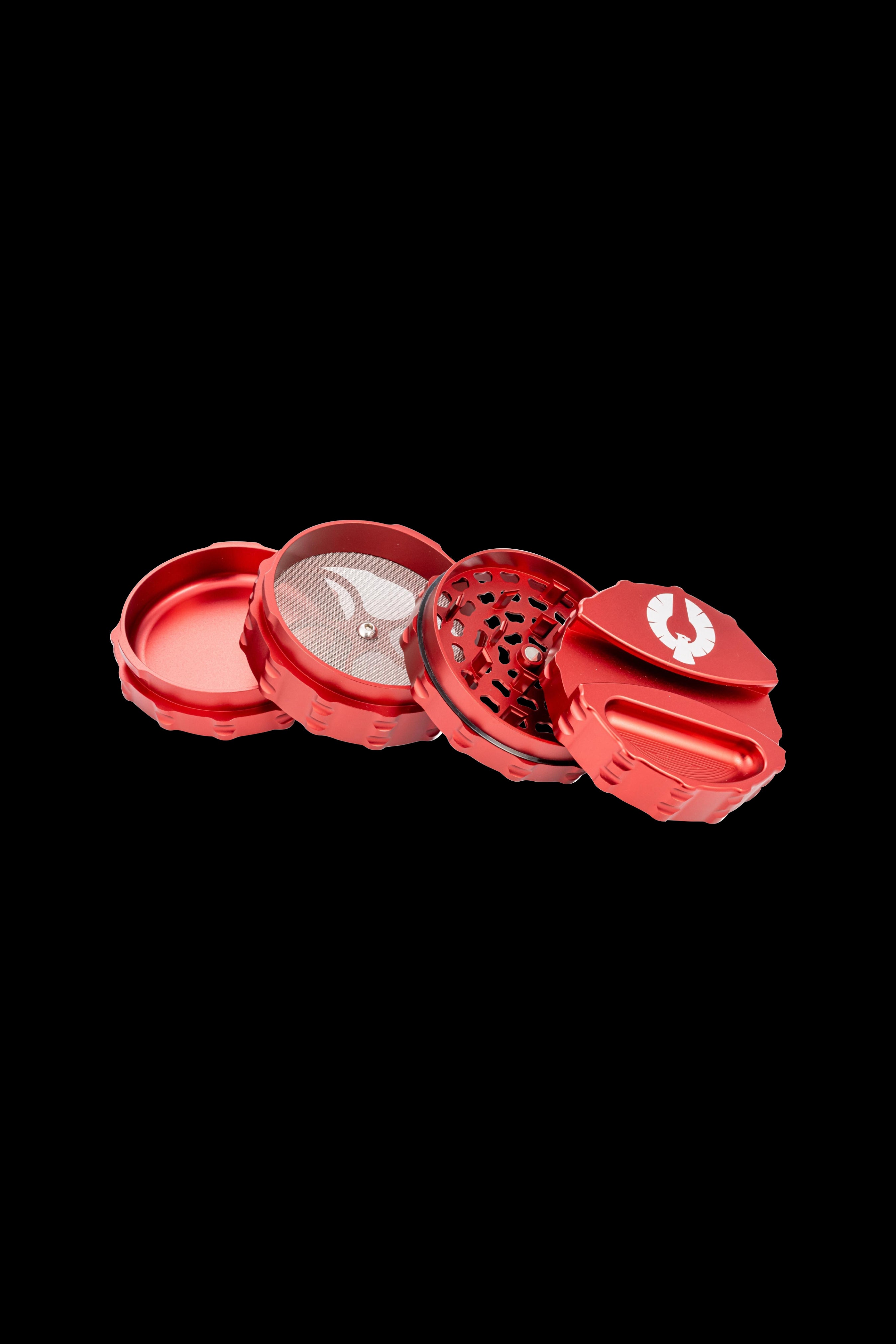 Red four-piece cannabis grinder with visible ground herb.
