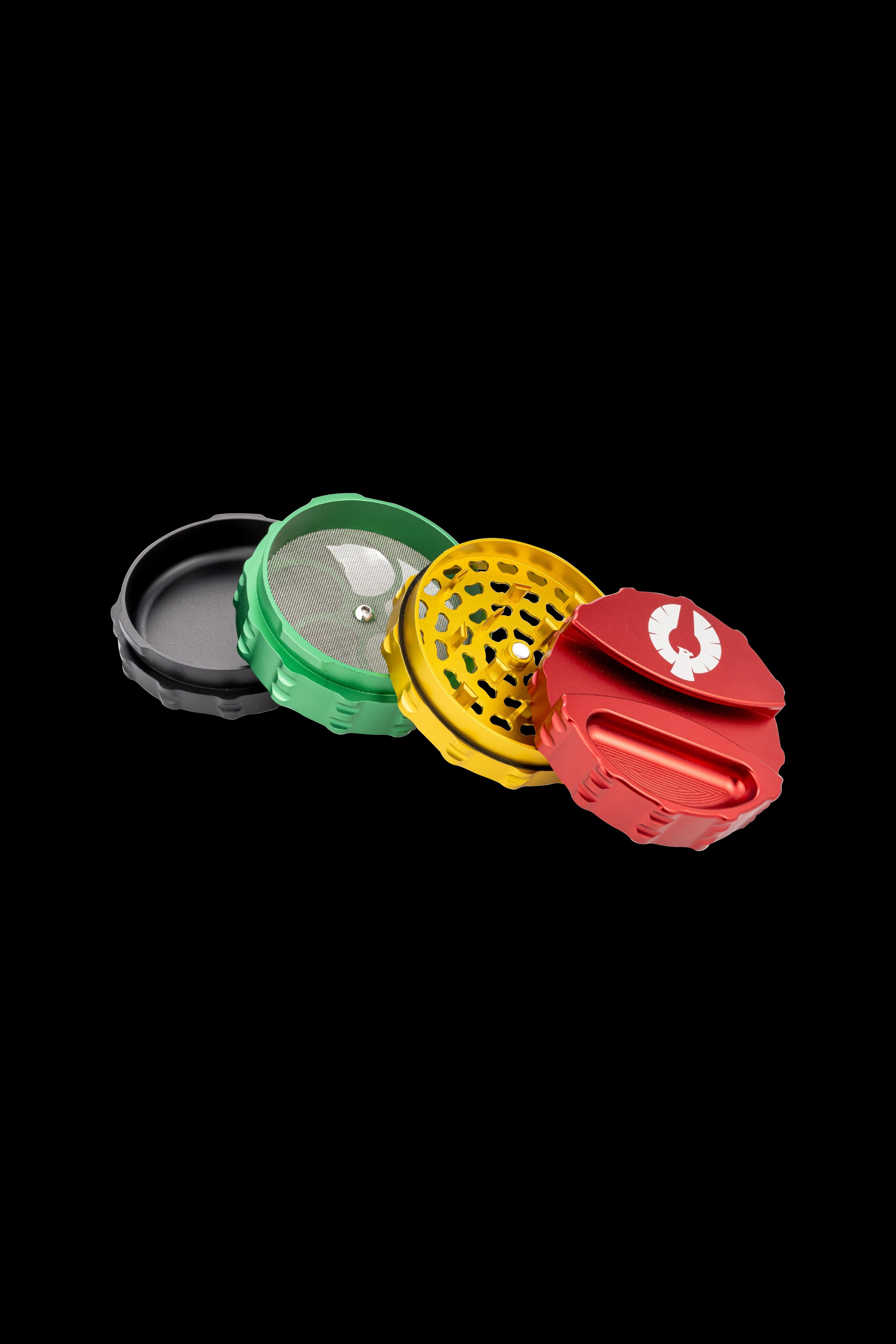 Colorful metal grinder disassembled into its component parts, showcasing a multi-tiered design with mesh and textured surfaces.