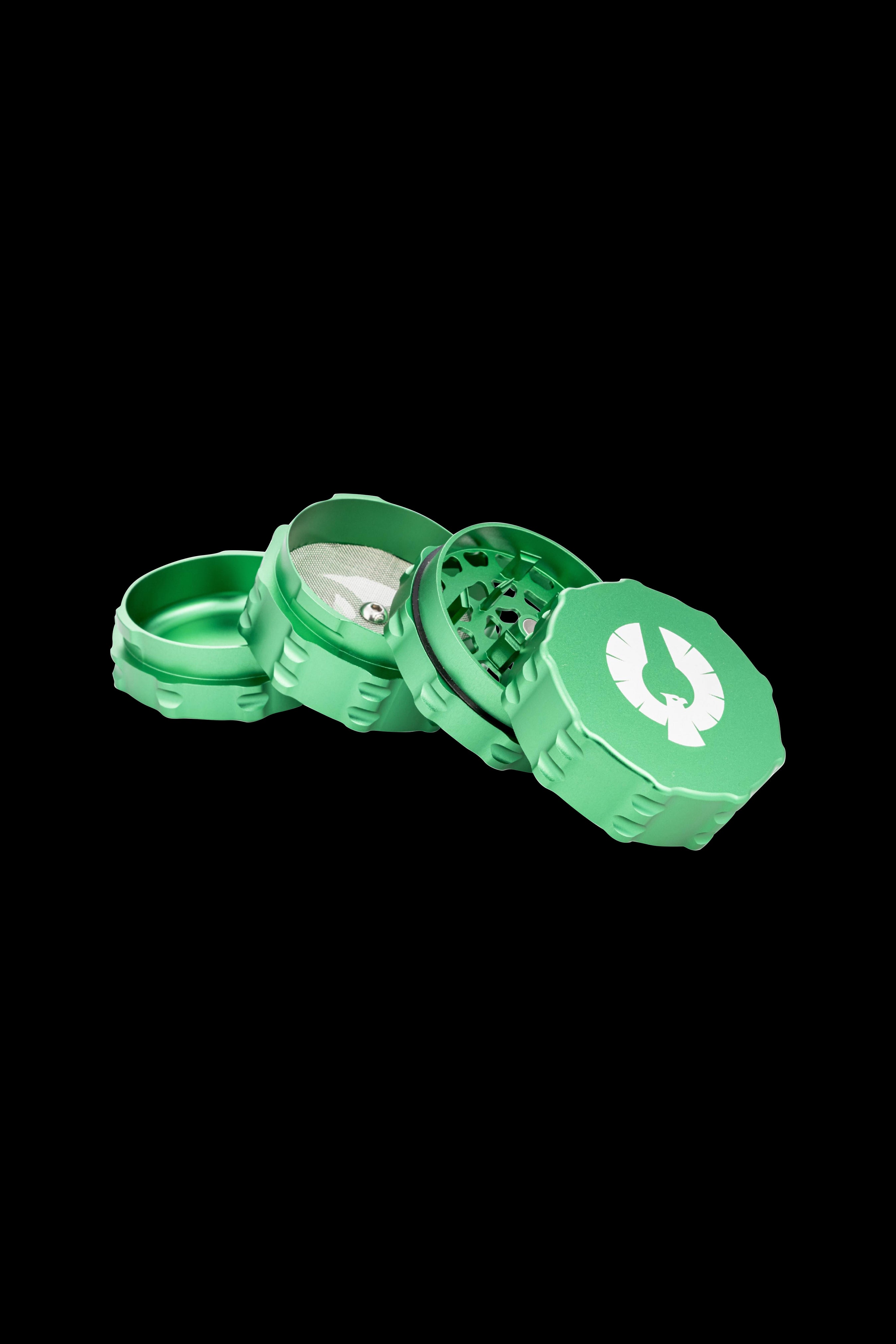 Green four-piece metal grinder with a white cannabis leaf logo.