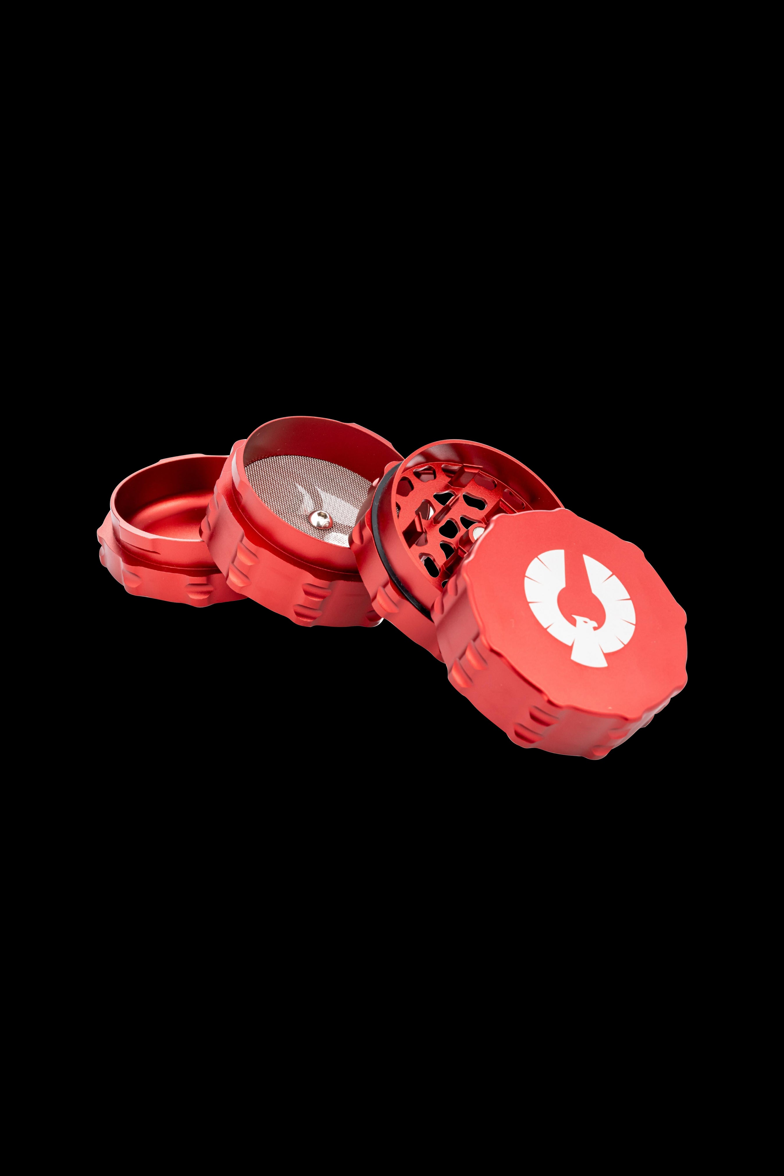 Red four-piece cannabis grinder with a white logo, disassembled on a black background.