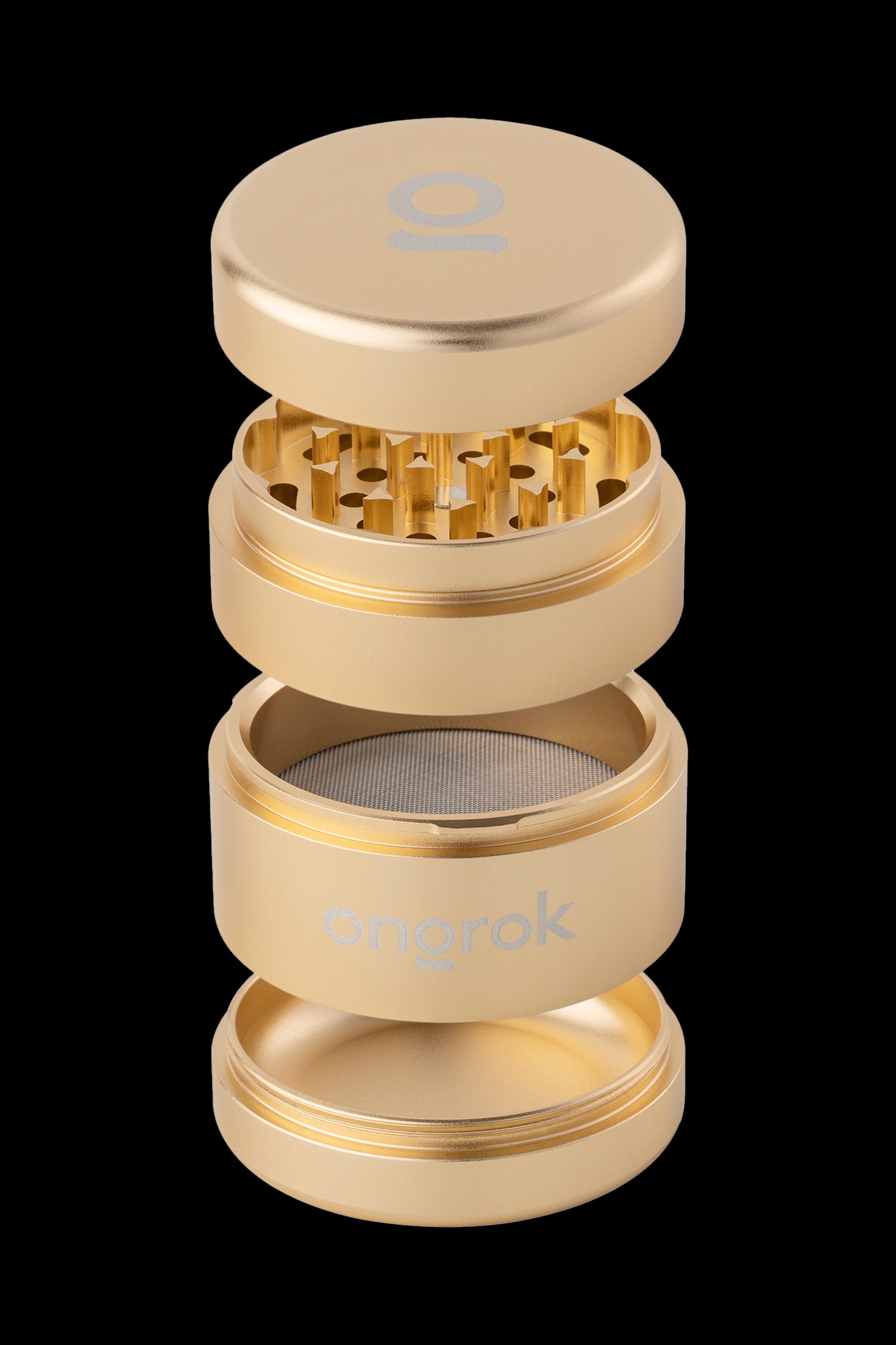 Gold four-piece cannabis grinder with visible grinding teeth and mesh screen.