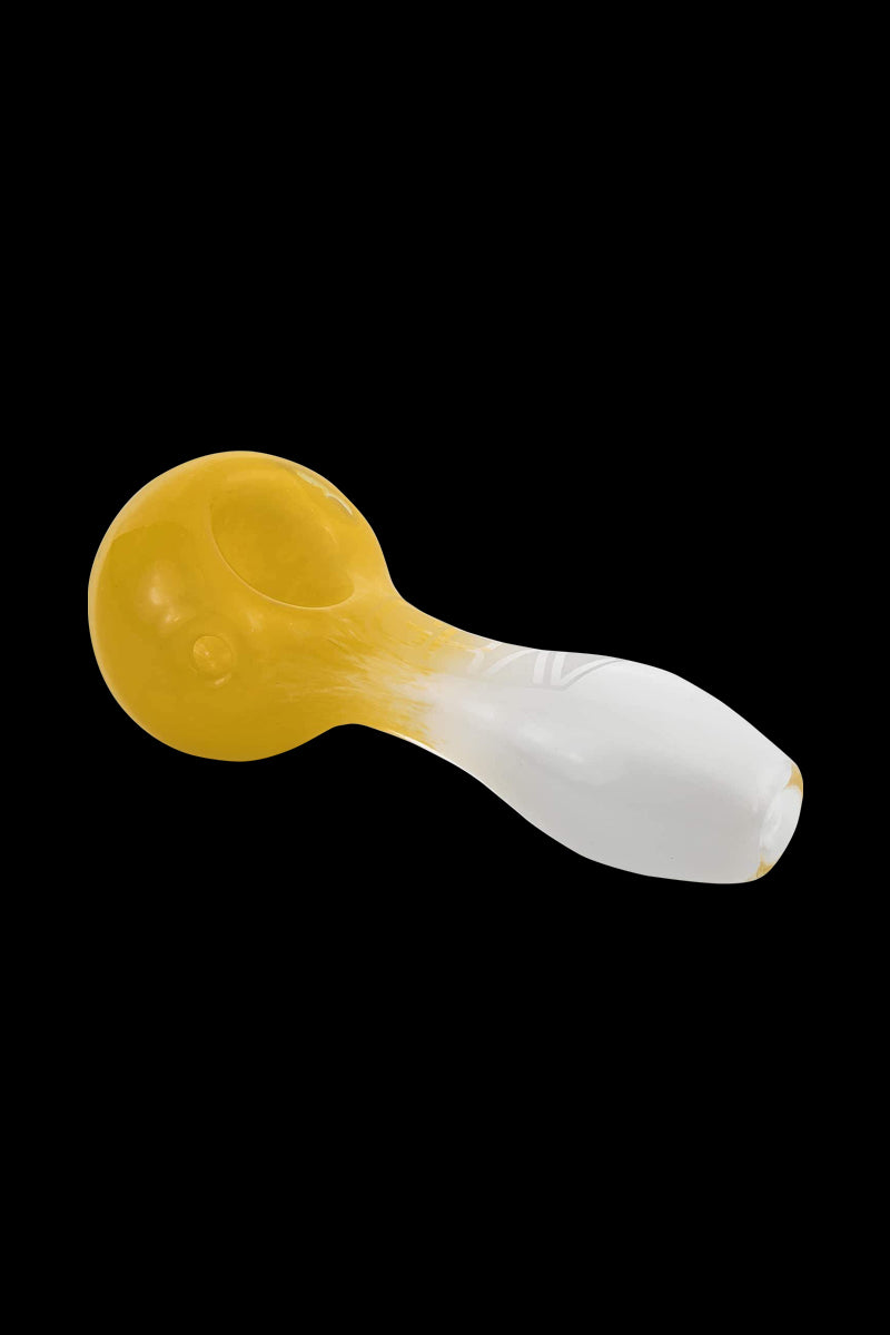 A close-up, angled view of the GRAV® Frit Spoon, showcasing its curved design and smooth, frosted glass finish.