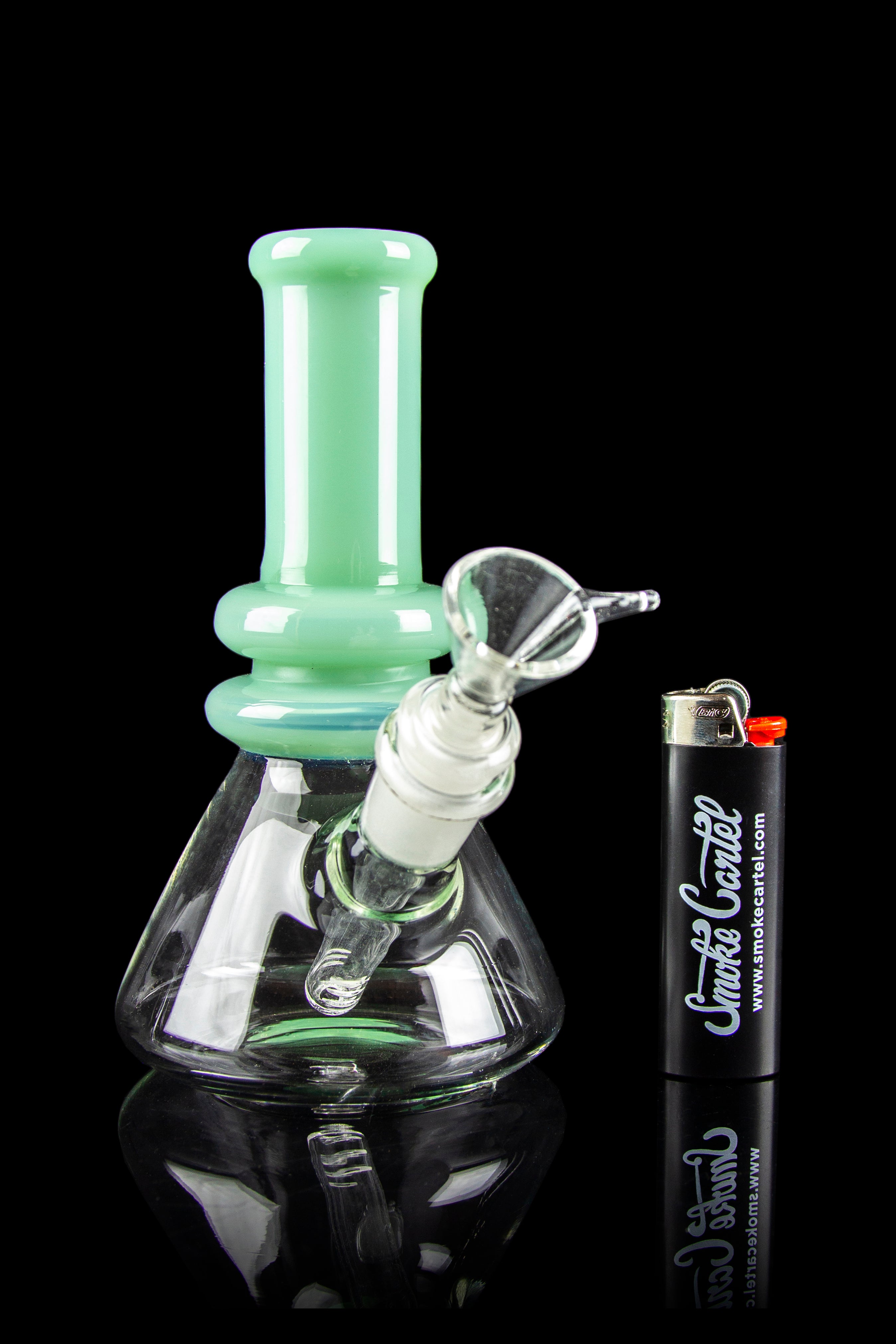 Mint green glass bong with smoke billowing inside, alongside a lighter branded with "Smoke Cartel."