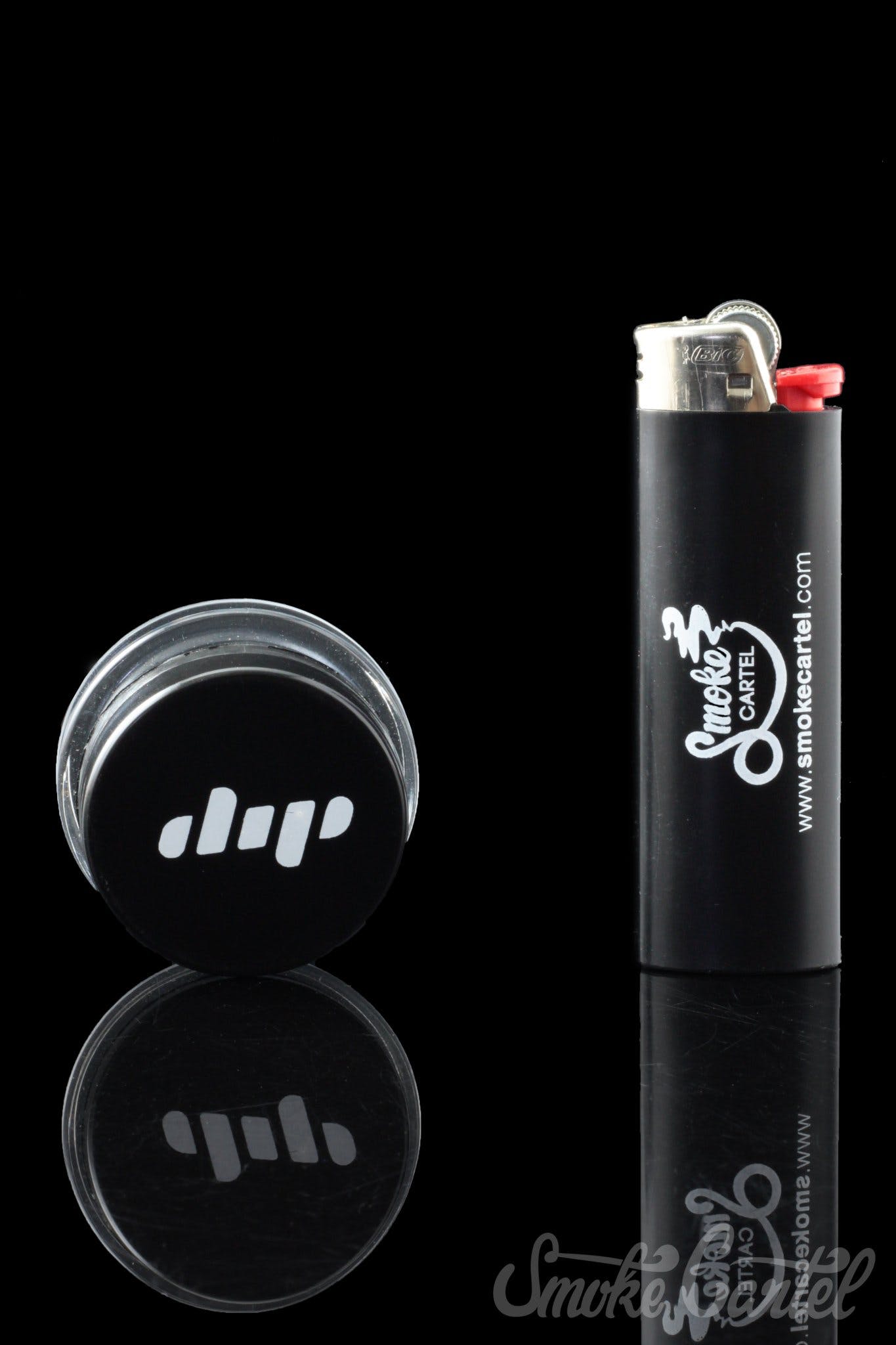 A studio shot of the Dip Devices 9mL Glass Container, reflecting against a dark surface.