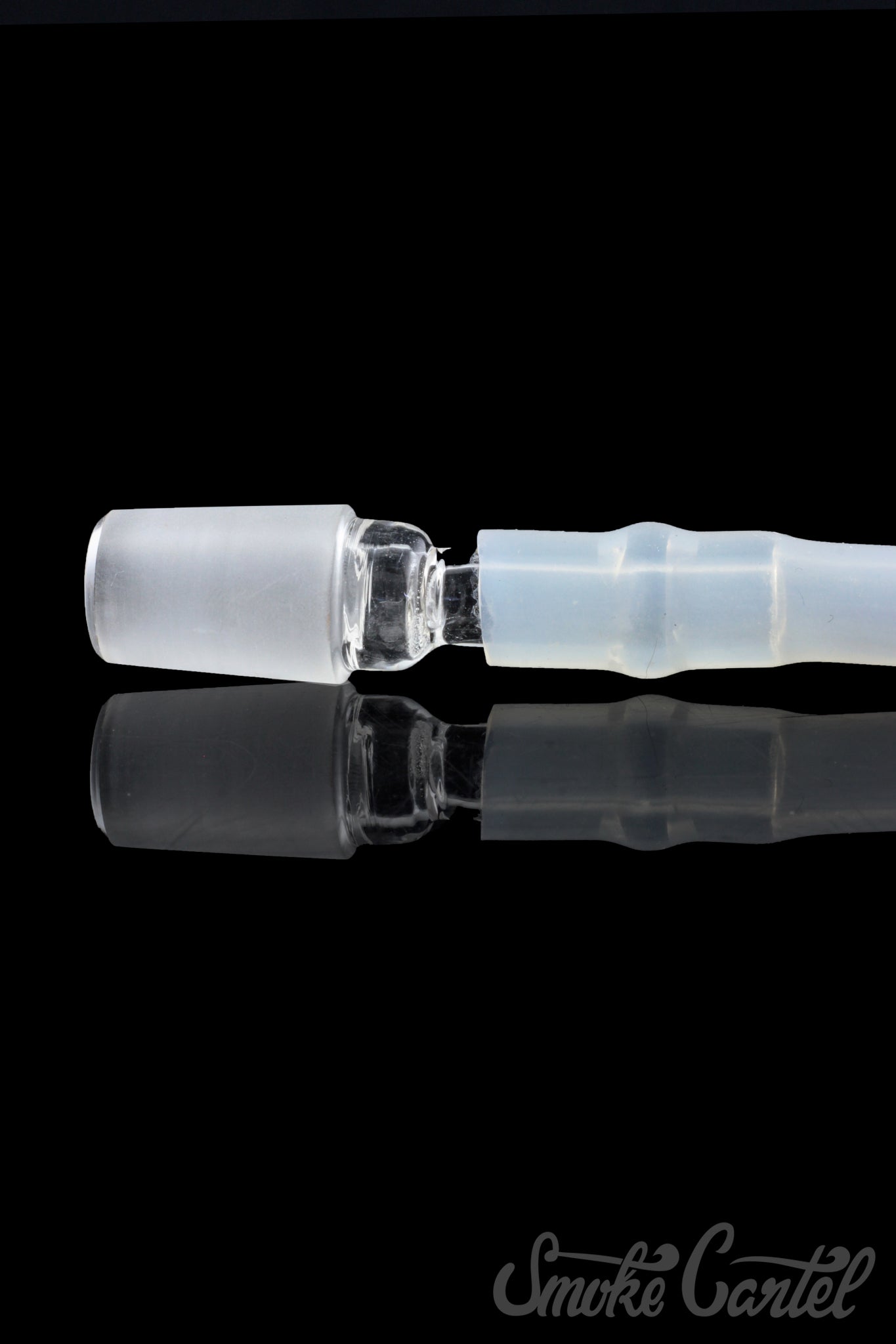 A close-up view of the clear glass Dip Devices DipWhip Attachment, reflecting light on its smooth, curved surface.