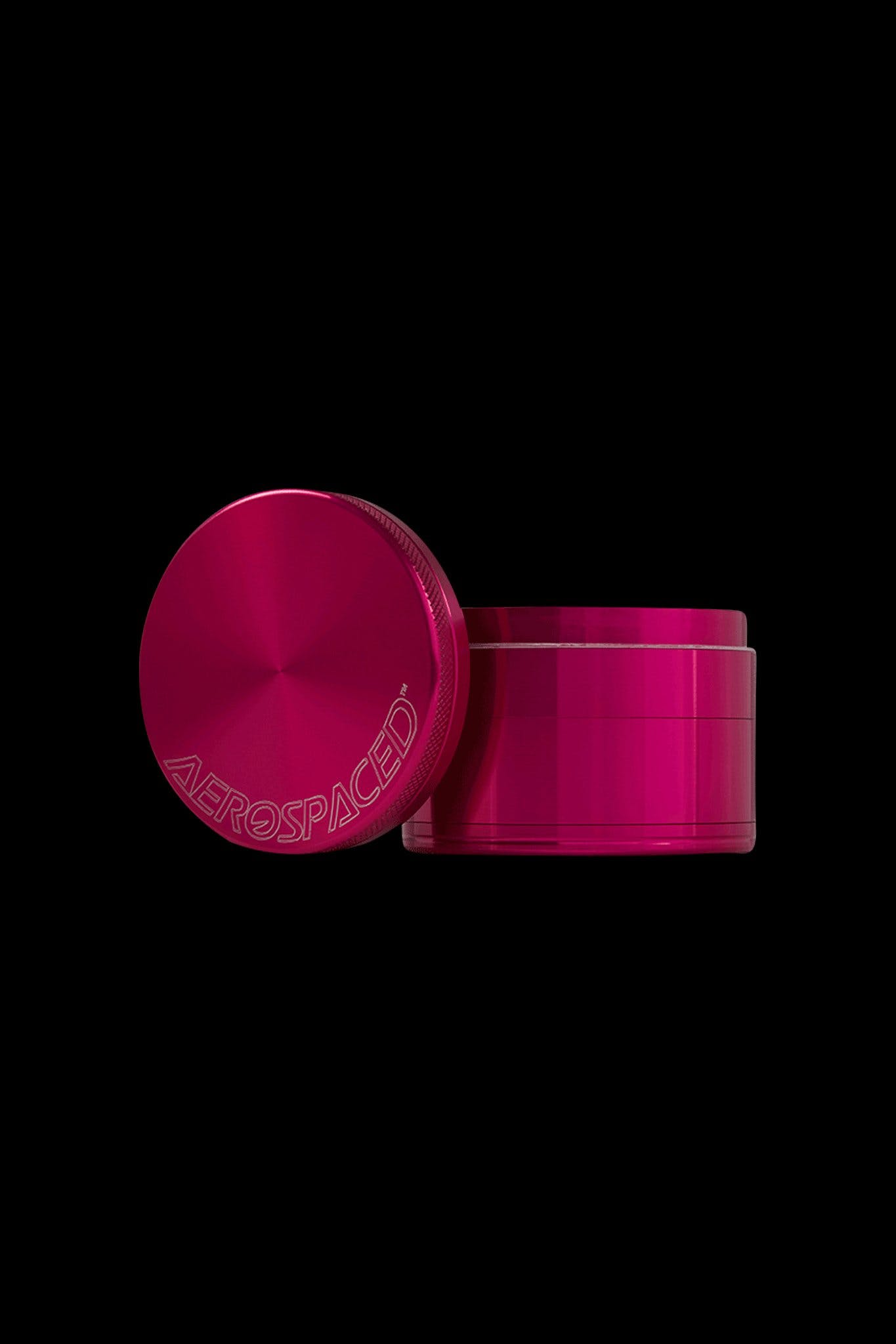 Hot pink cannabis grinder with “AEROSPACED” etched on the lid.