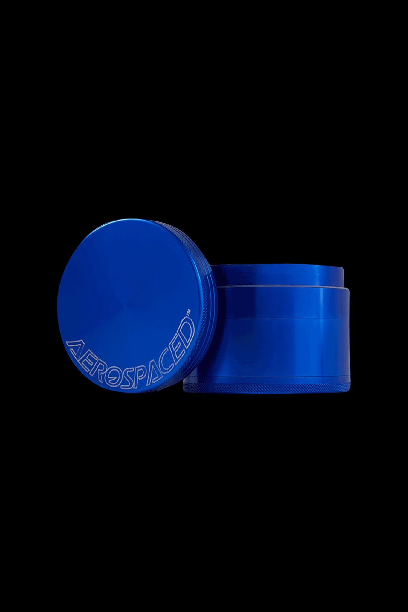 Blue four-piece metal grinder with “AEROSPACED” etched around the lid, isolated on a black background.