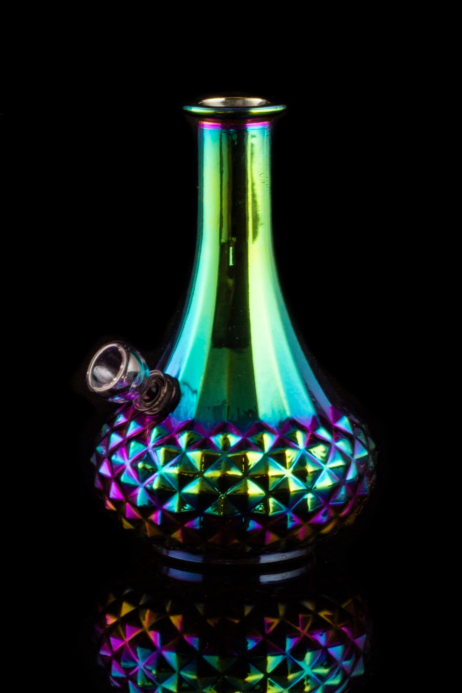 Iridescent glass water pipe with a studded base, isolated on black.