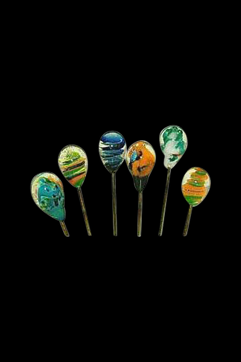 Row of six Handblown Glass Hair Pin / Poker pins with colorful teardrop glass heads against a black background