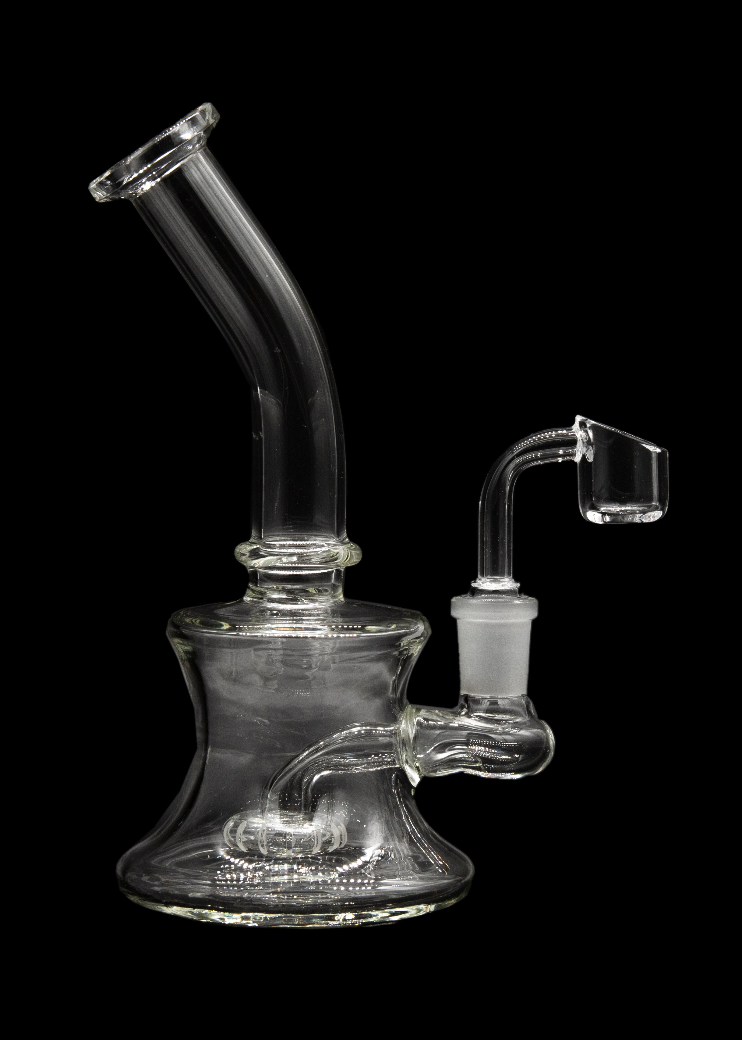 Clear glass dab rig with a quartz banger, isolated on a black background.