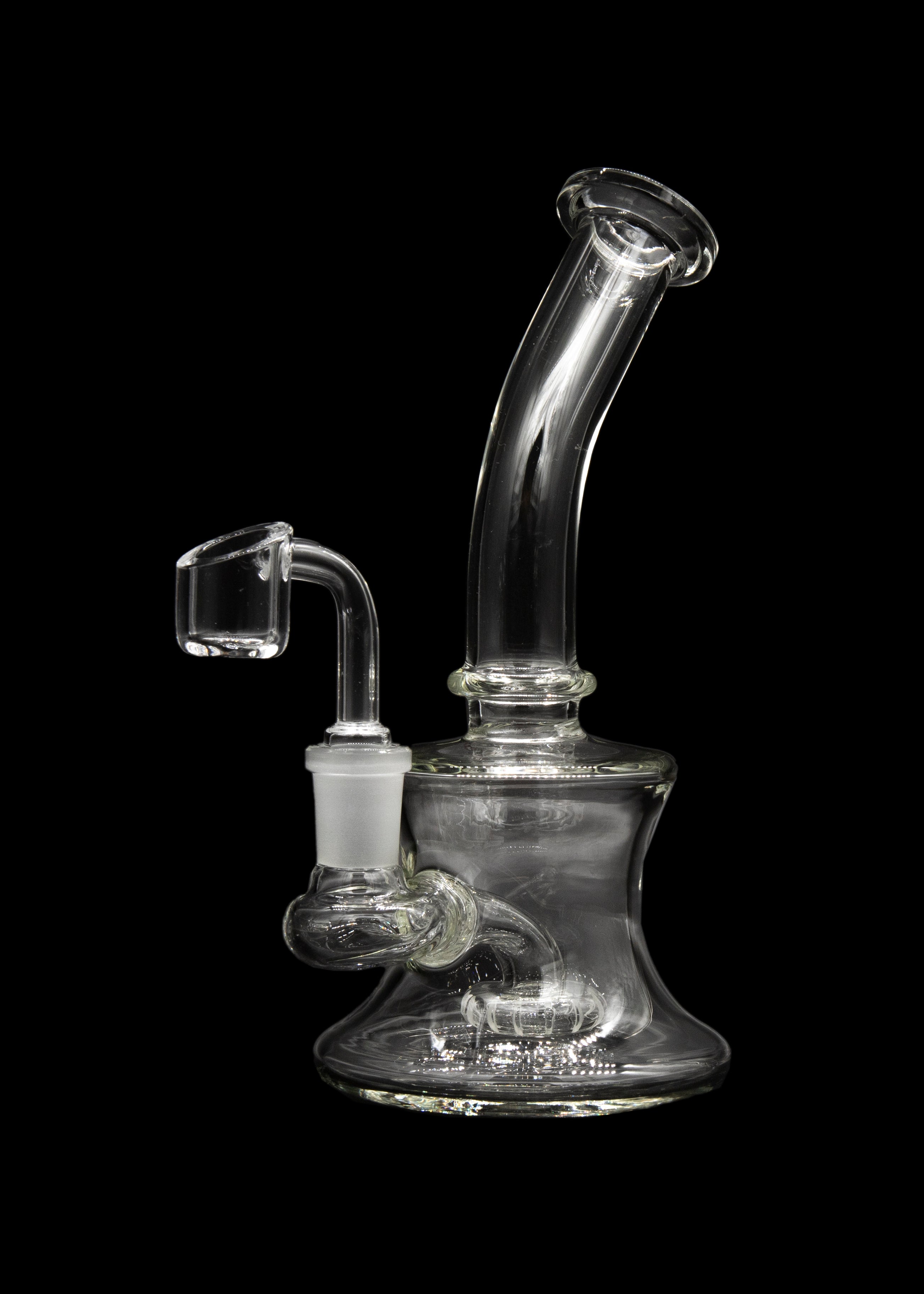 Clear glass dab rig with a quartz banger, isolated on a black background.