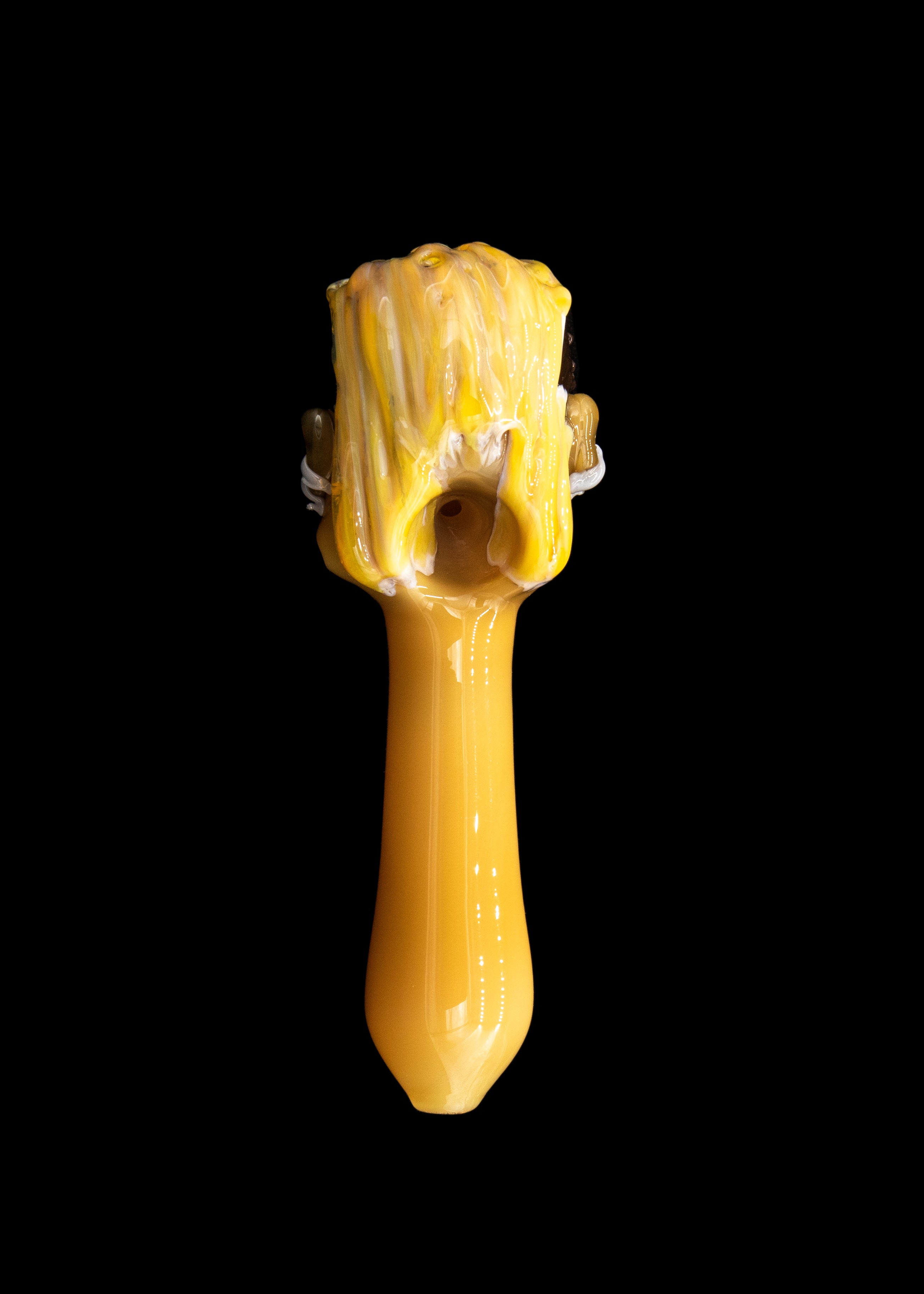 Golden glass pipe against a black background.
