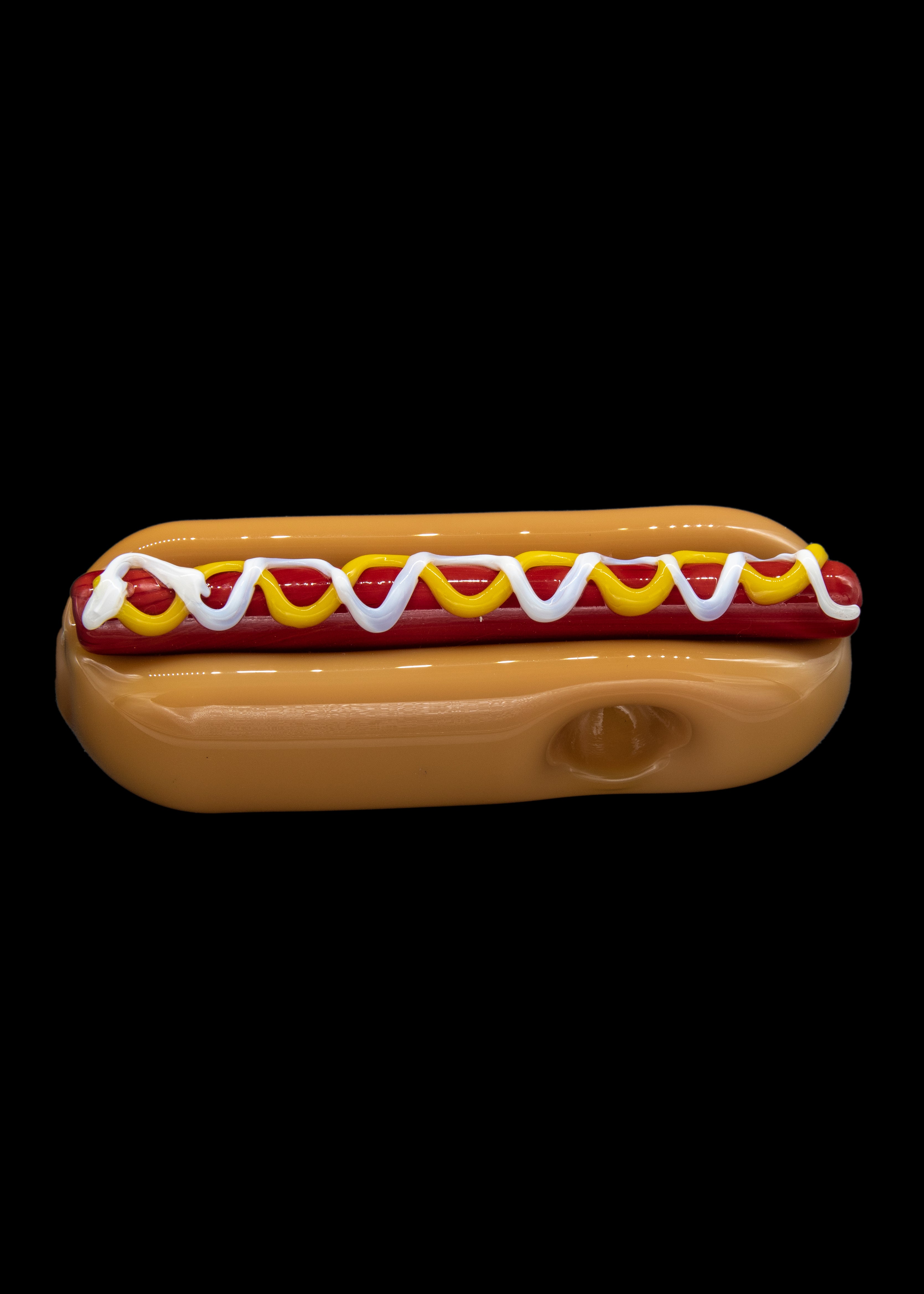 Glass pipe shaped like a hot dog with mustard and ketchup.
