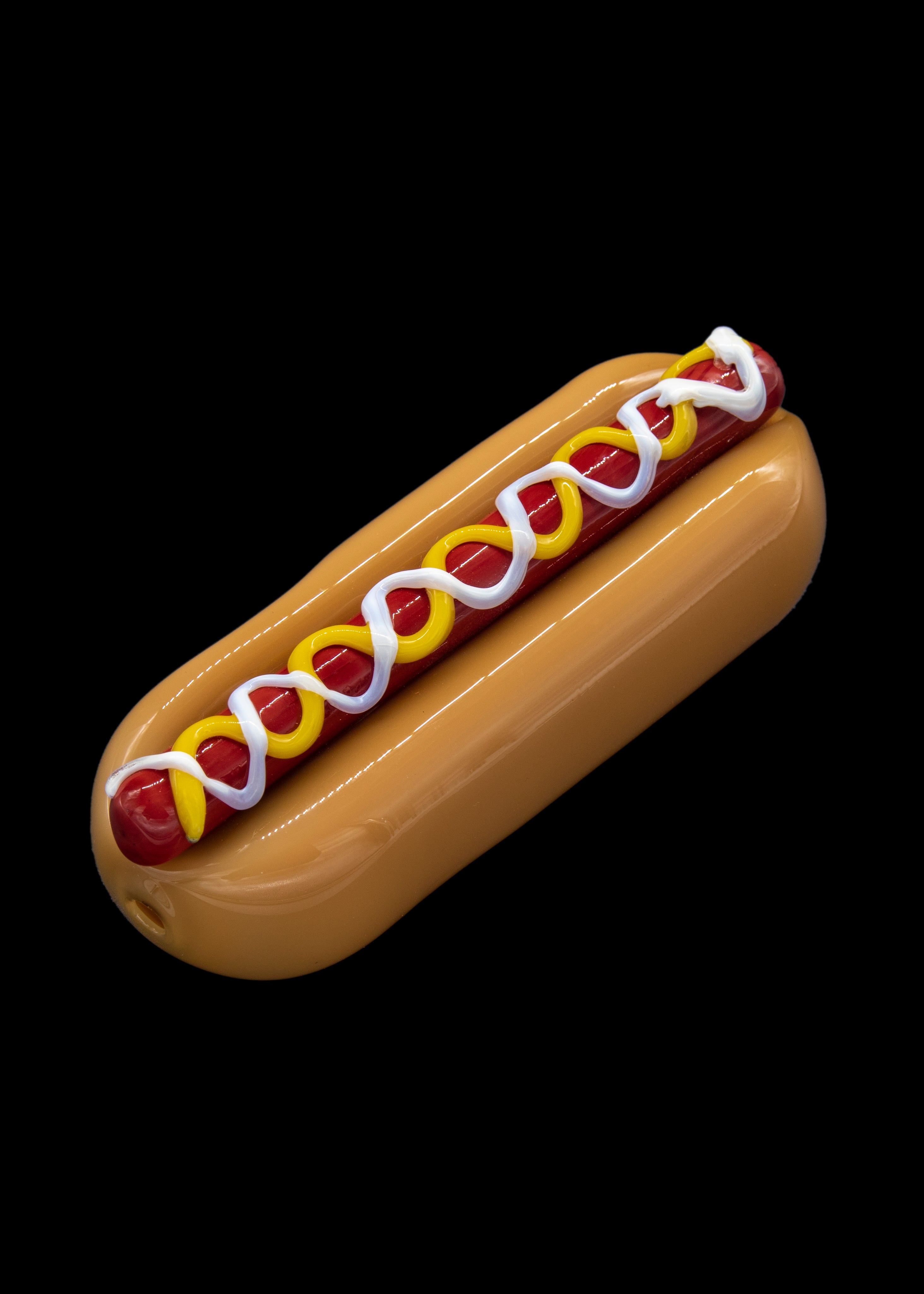 Glass pipe resembling a hot dog with colorful accents.