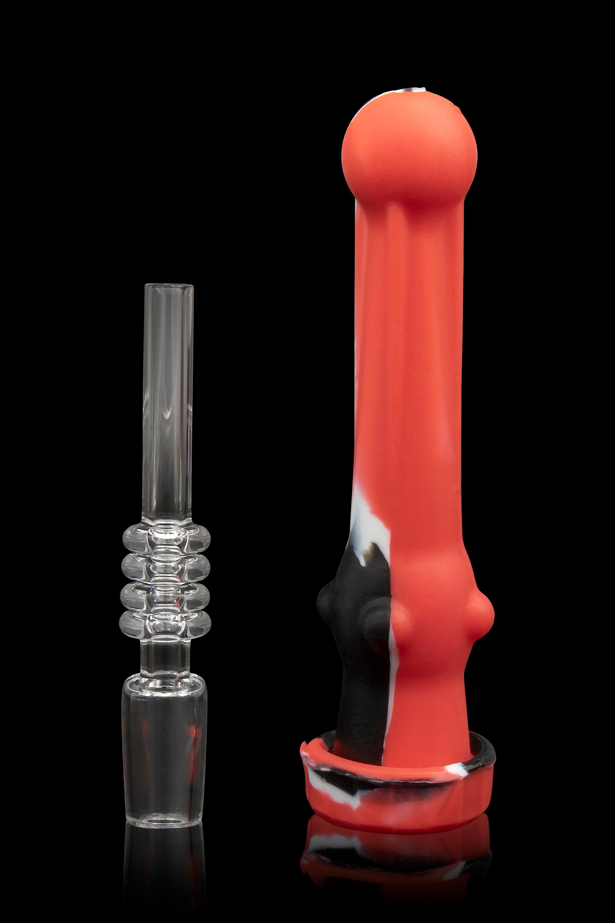 Red and white silicone dab rig with a glass downstem, displayed on a reflective surface.