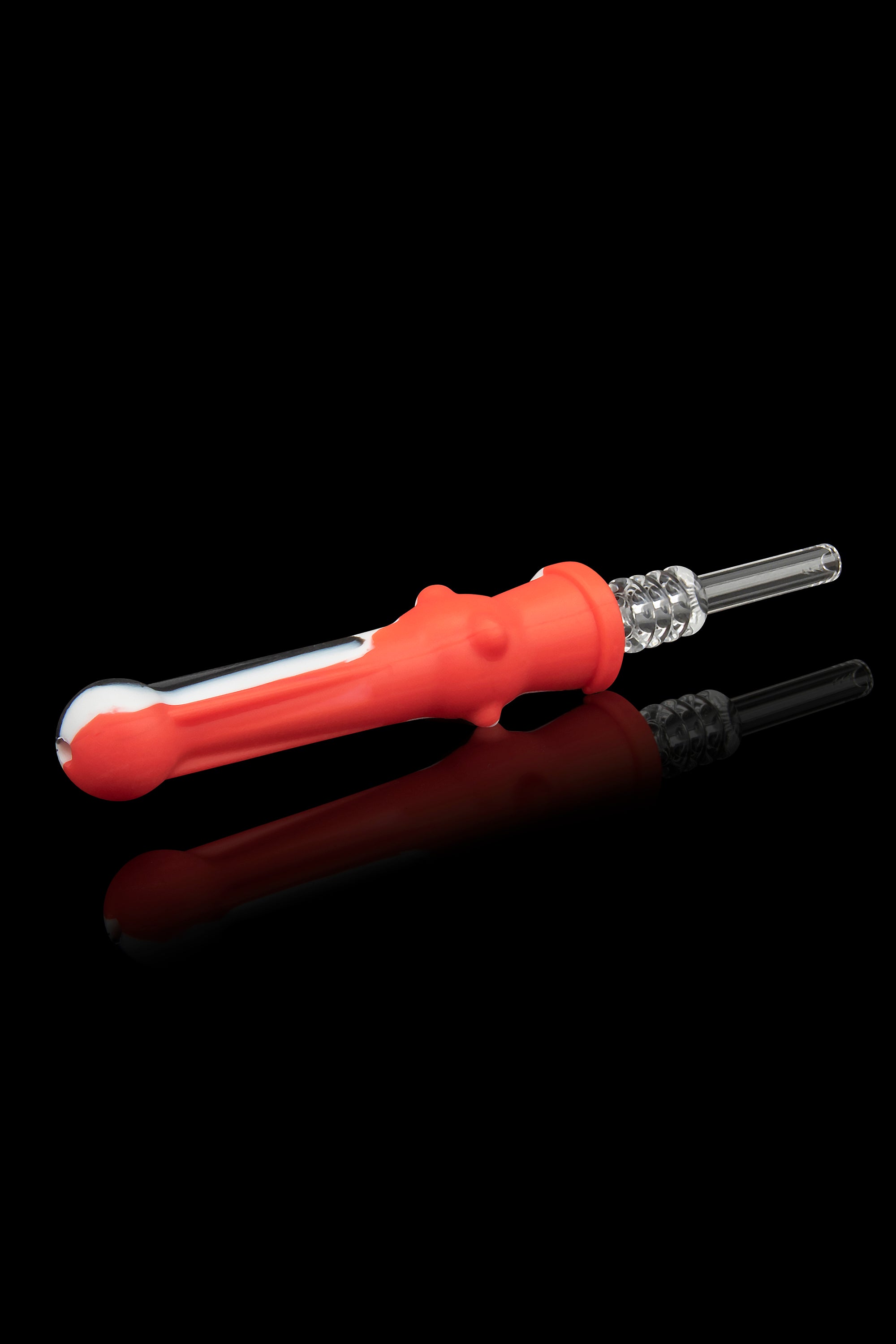 Red silicone dab tool with glass tip and accompanying glass insert, displayed on a reflective surface.