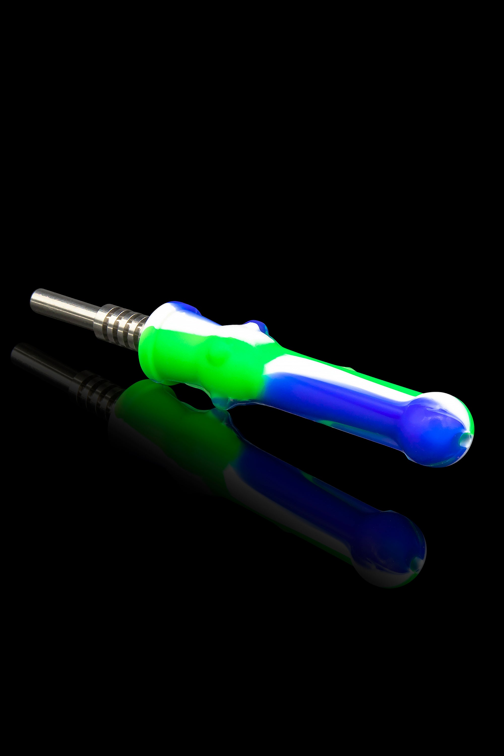 Colorful silicone dab tool with a metal tip, reflecting on a glossy surface.