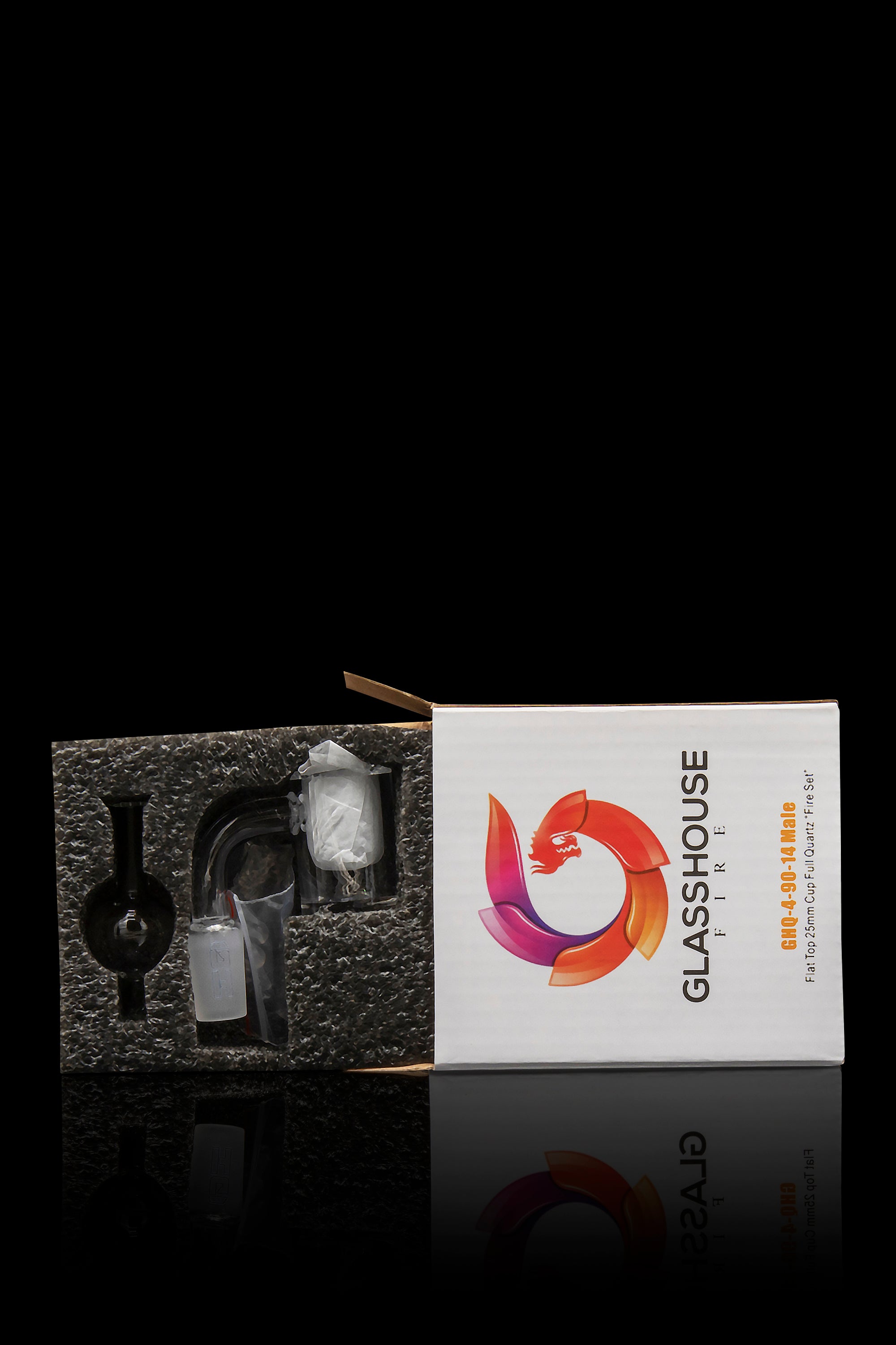 A boxed cannabis accessory, specifically a "Glasshouse Fire" nail and carb cap set for dabbing, displayed against a dark, reflective surface.