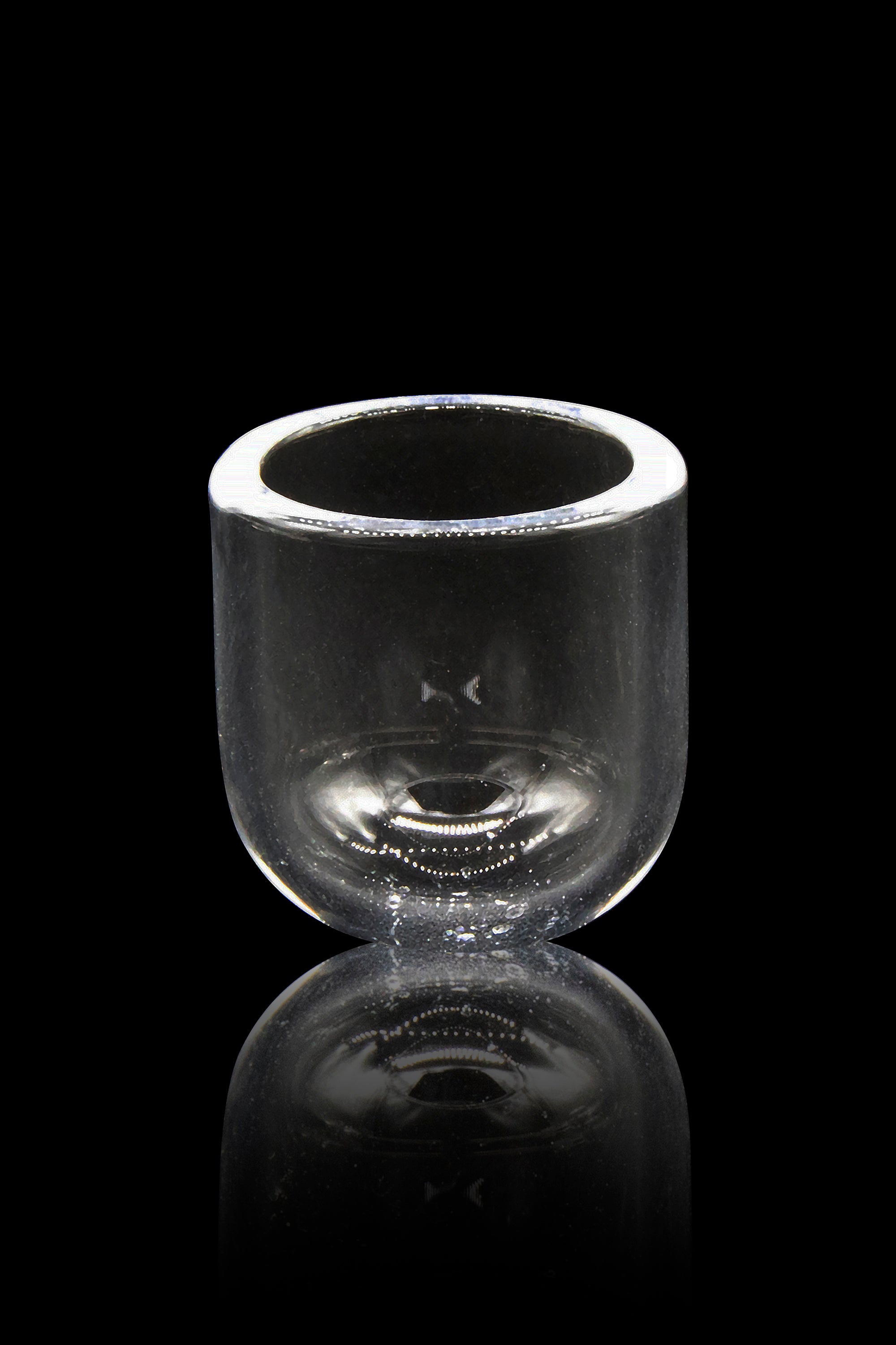 Clear glass bubbler with a reflective surface, isolated on black.