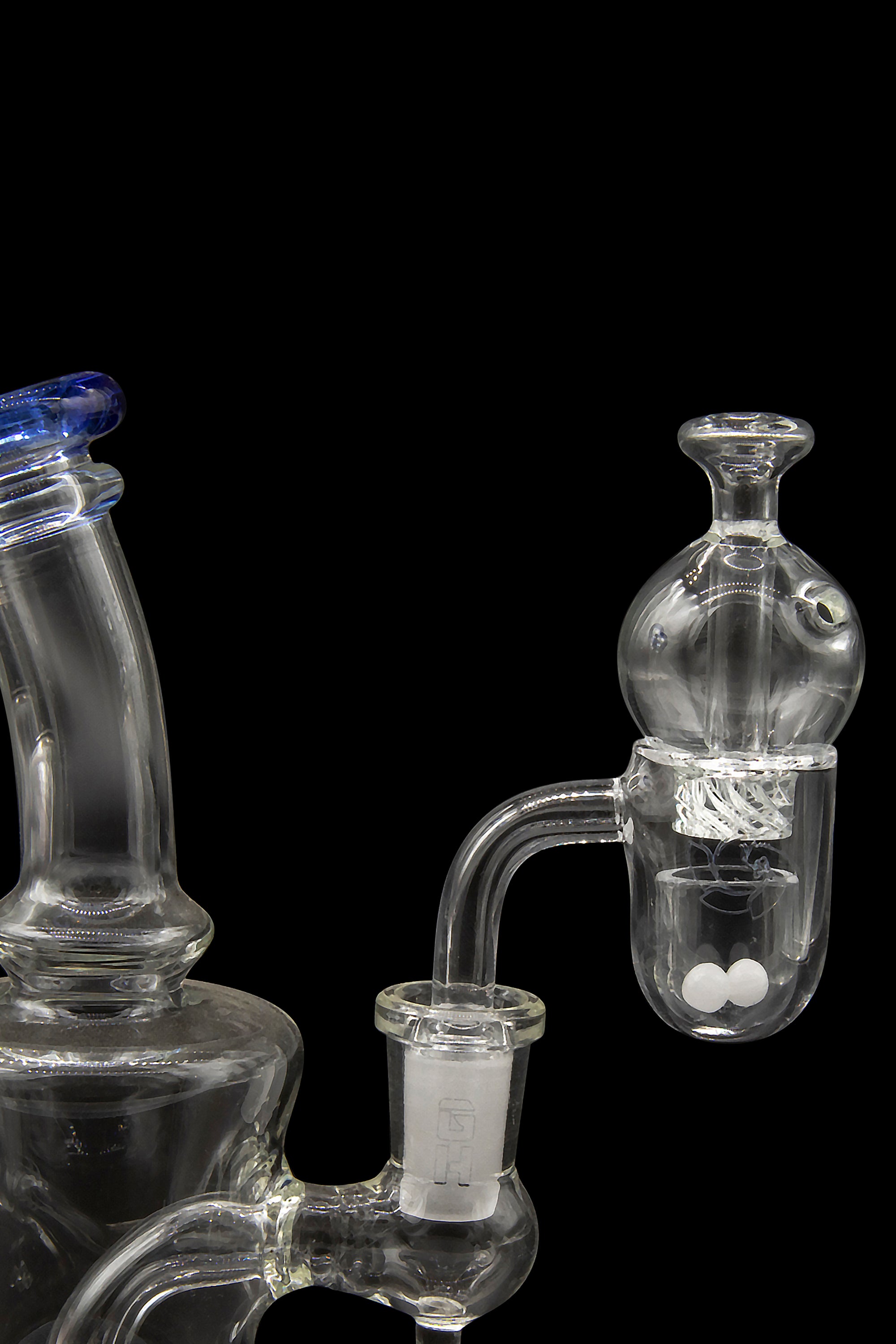 Glass water pipe and bubbler with clear glass and blue accents, isolated on a black background.