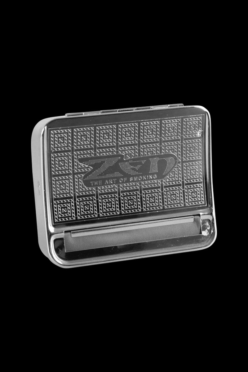 Angled front view of the chrome Zen Metal Auto-Roll Box with textured geometric lid pattern and embossed logo on a black background.