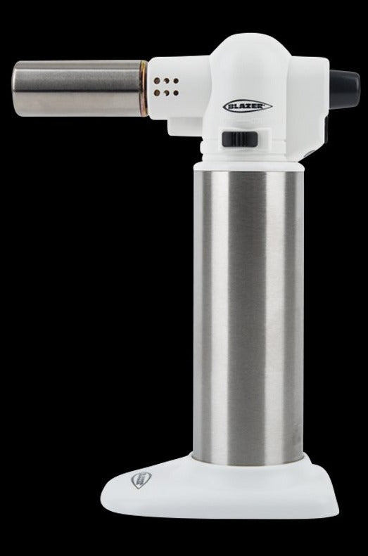 Side view of a blue w/ stainless steel Blazer Big Buddy Turbo Torch standing upright against a black background.