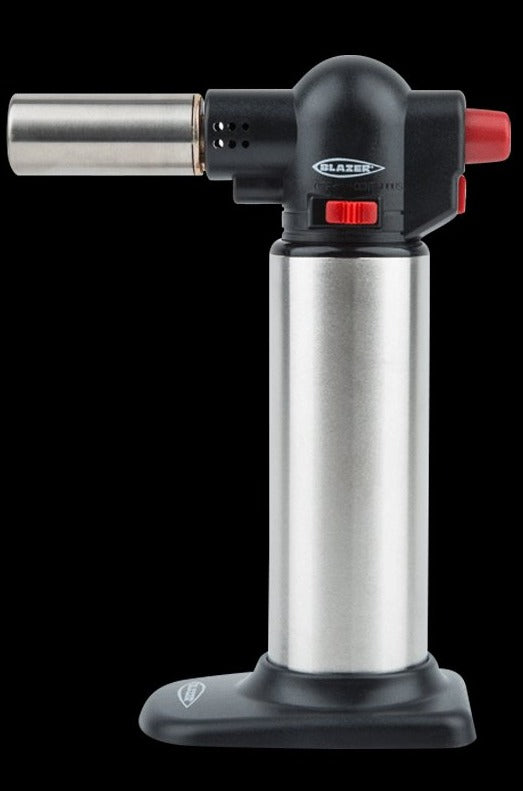 Front-facing view of a Black w/ Stainless Steel Blazer Big Buddy Turbo Torch standing upright on its black base against a black background