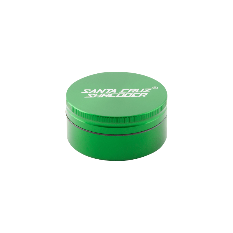 Top-down view of a matte green Santa Cruz Shredder 2-Piece Grinder showing the ridged lid edge and white logo on a white background