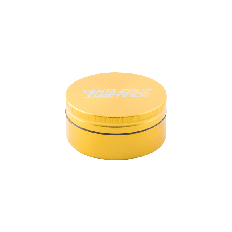Low-angle front view of a matte yellow Santa Cruz Shredder 2-Piece Grinder showing its ridged lid and white logo on a white background