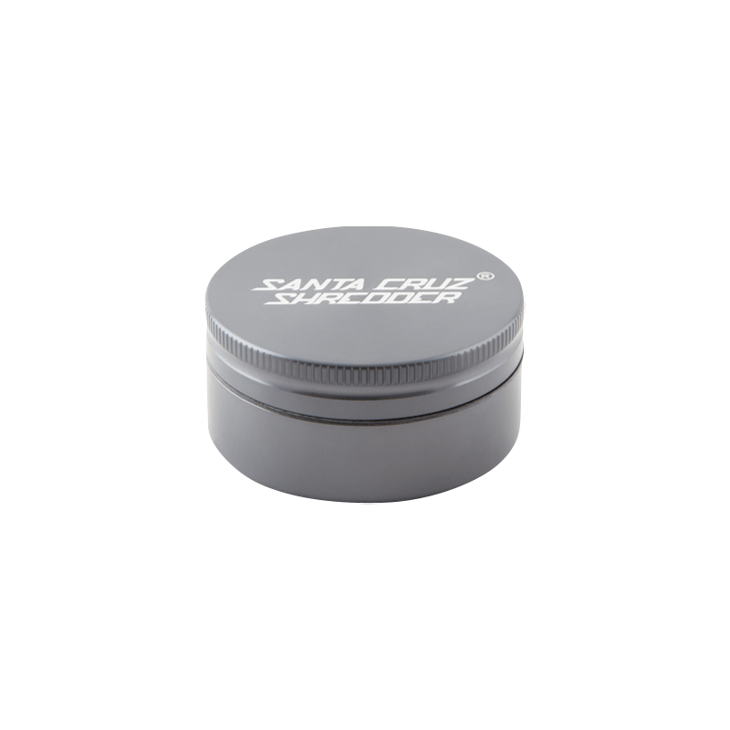 Top-down view of the green Santa Cruz Shredder 2-Piece Grinder showing its round screw-top lid with white logo and subtle shadow.