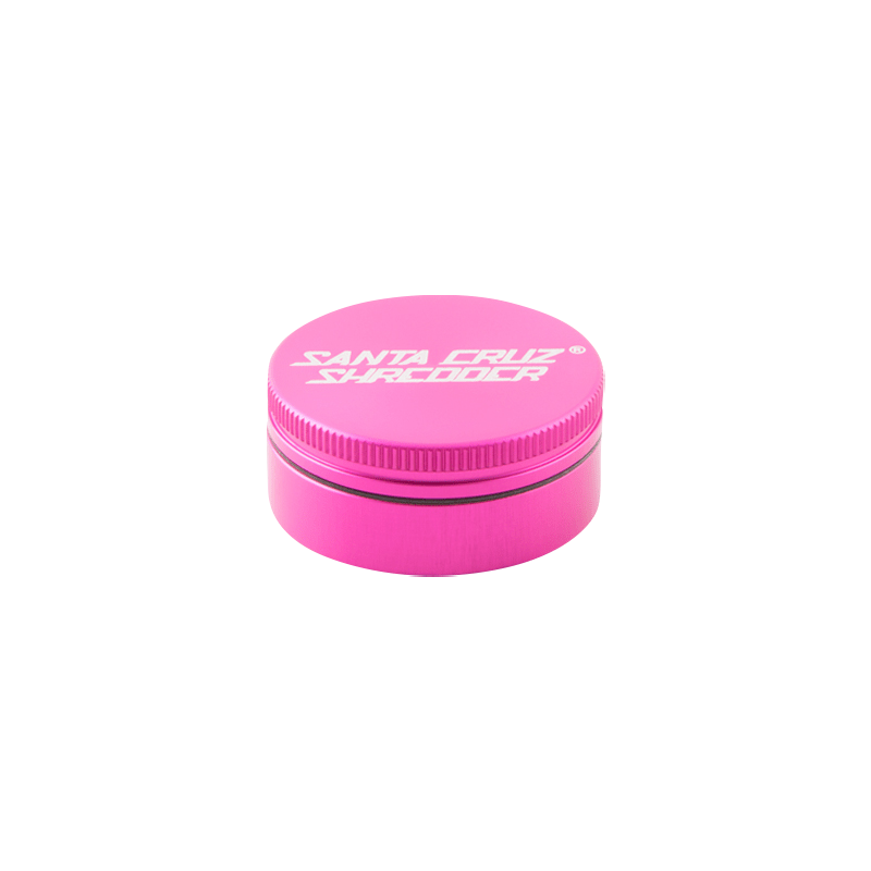 Top-down view of a matte pink Santa Cruz Shredder 2-Piece Grinder centered on a white background, showing the ribbed edge and white logo on the lid.