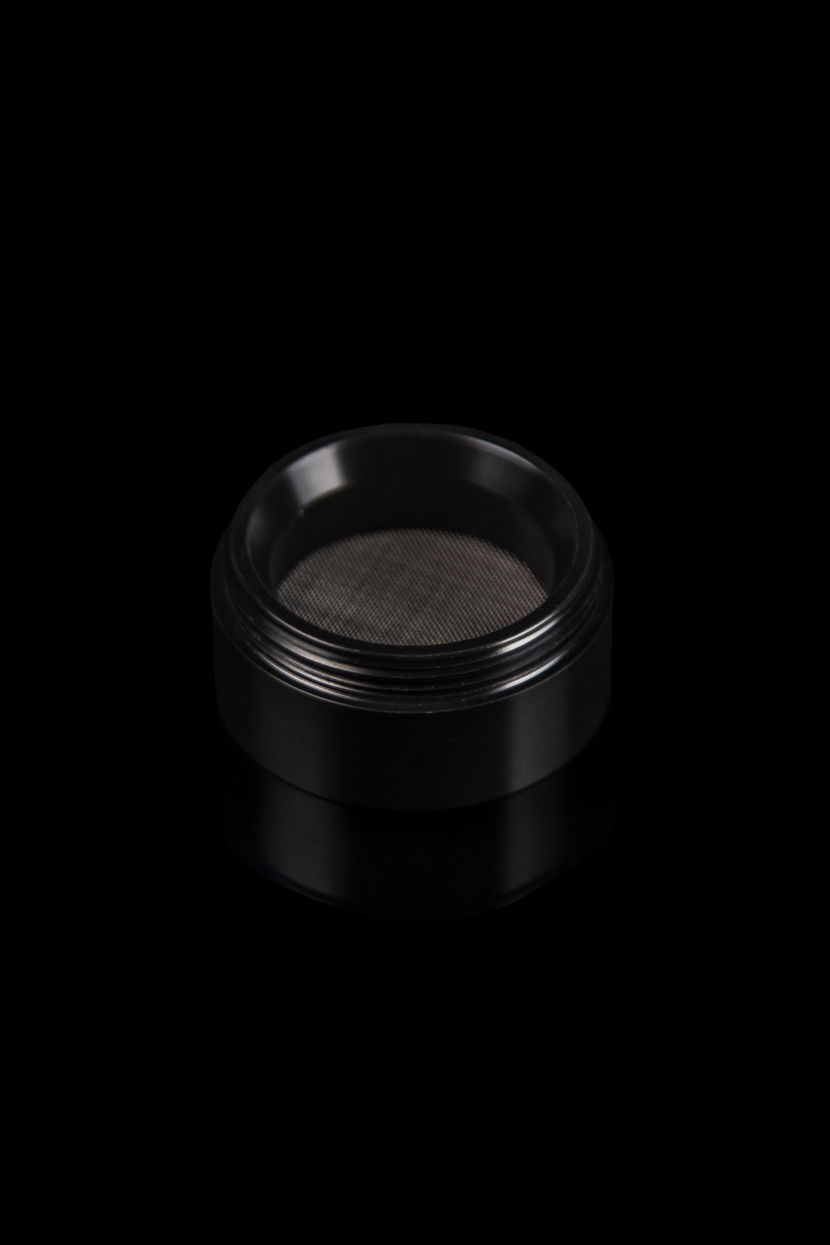 Black metal grinder with mesh screen.