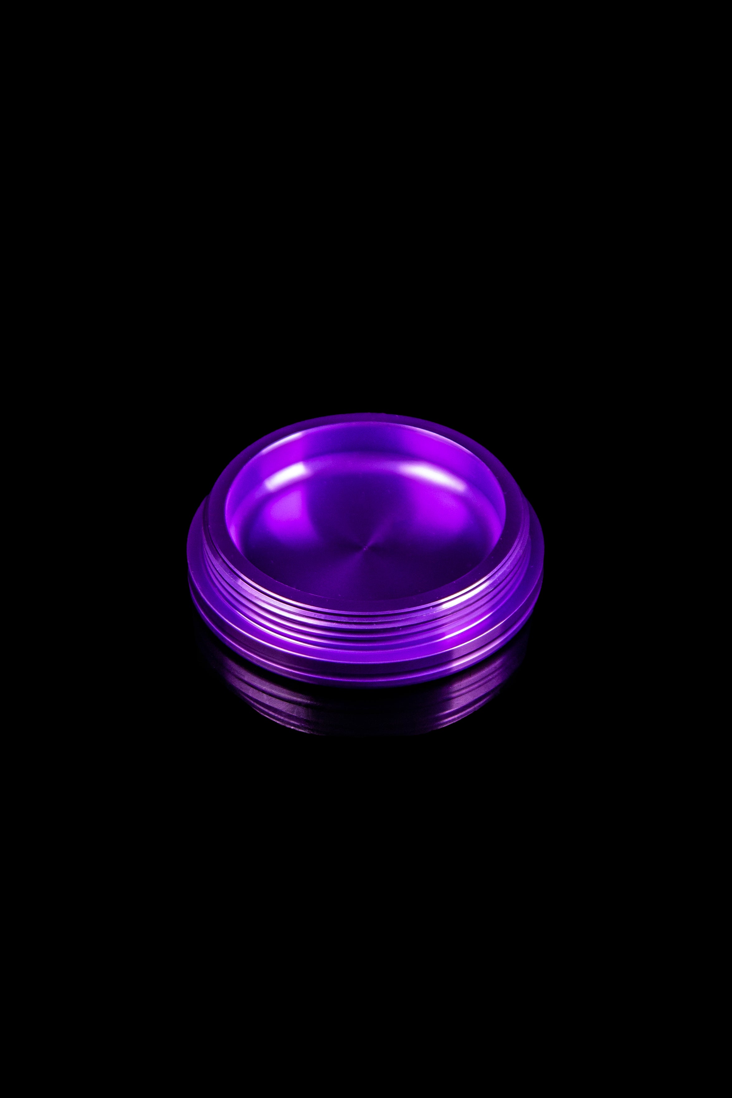 Purple cannabis dab tool on black background.