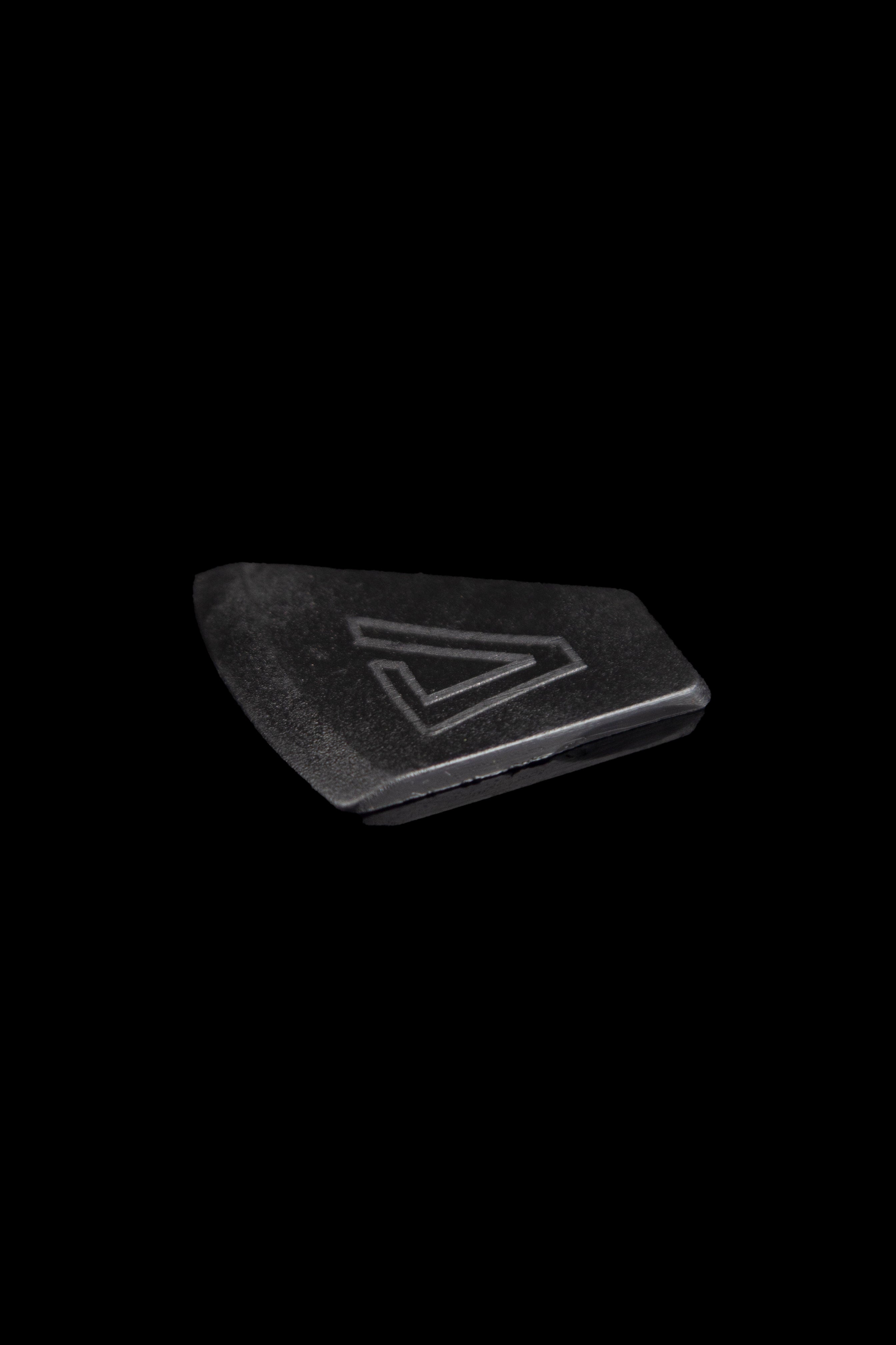Black cannabis accessory with a geometric logo.