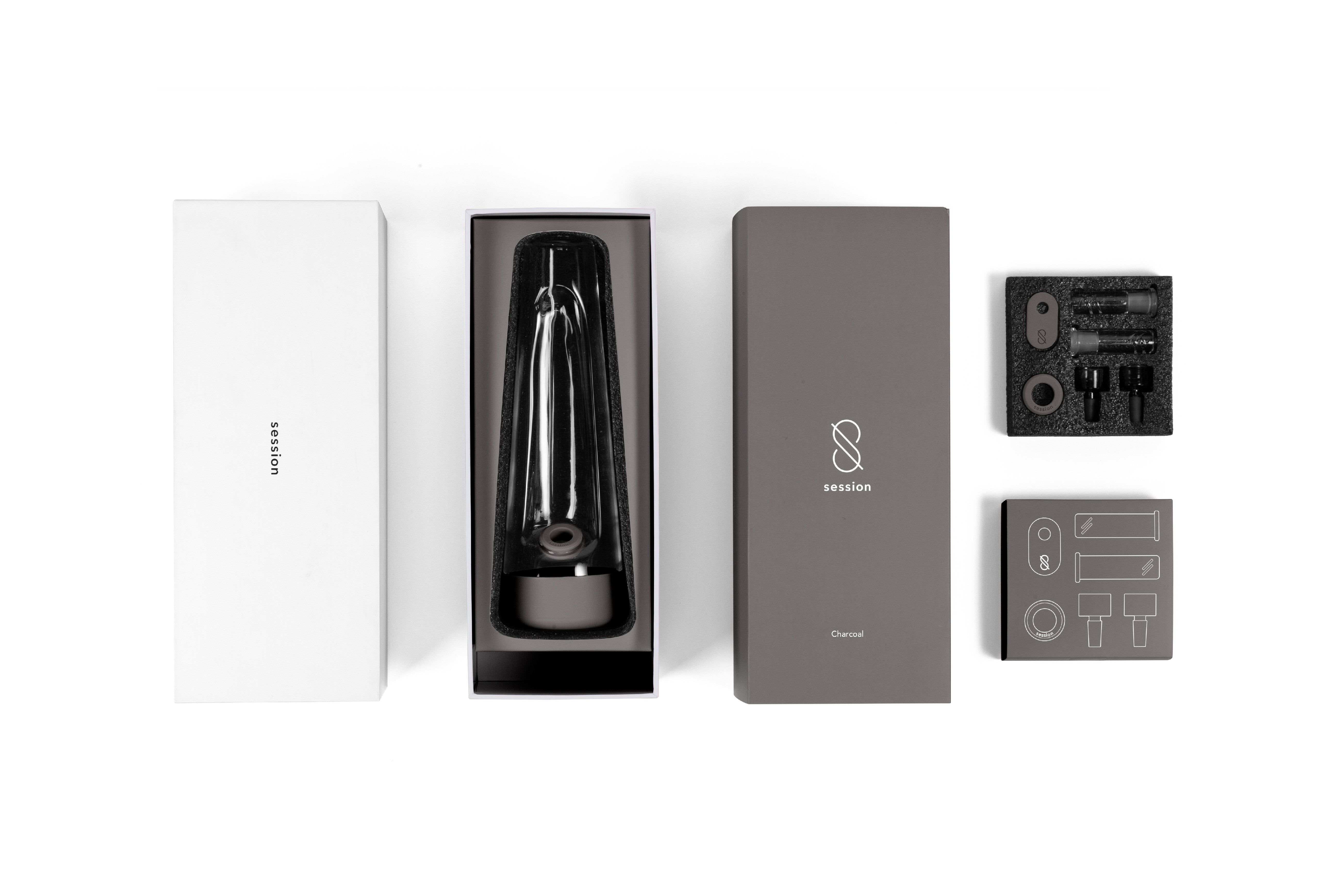 Top-down view of the Session Goods Modern Bong kit in charcoal packaging with the glass piece nestled in foam and accessories arranged alongside.