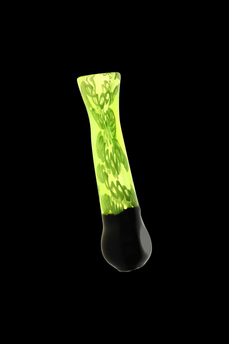 Angled studio shot of the Acid Green Worked Glass Taster Chillum showing a neon green shaft with black tip and internal spiral swirl against a black background
