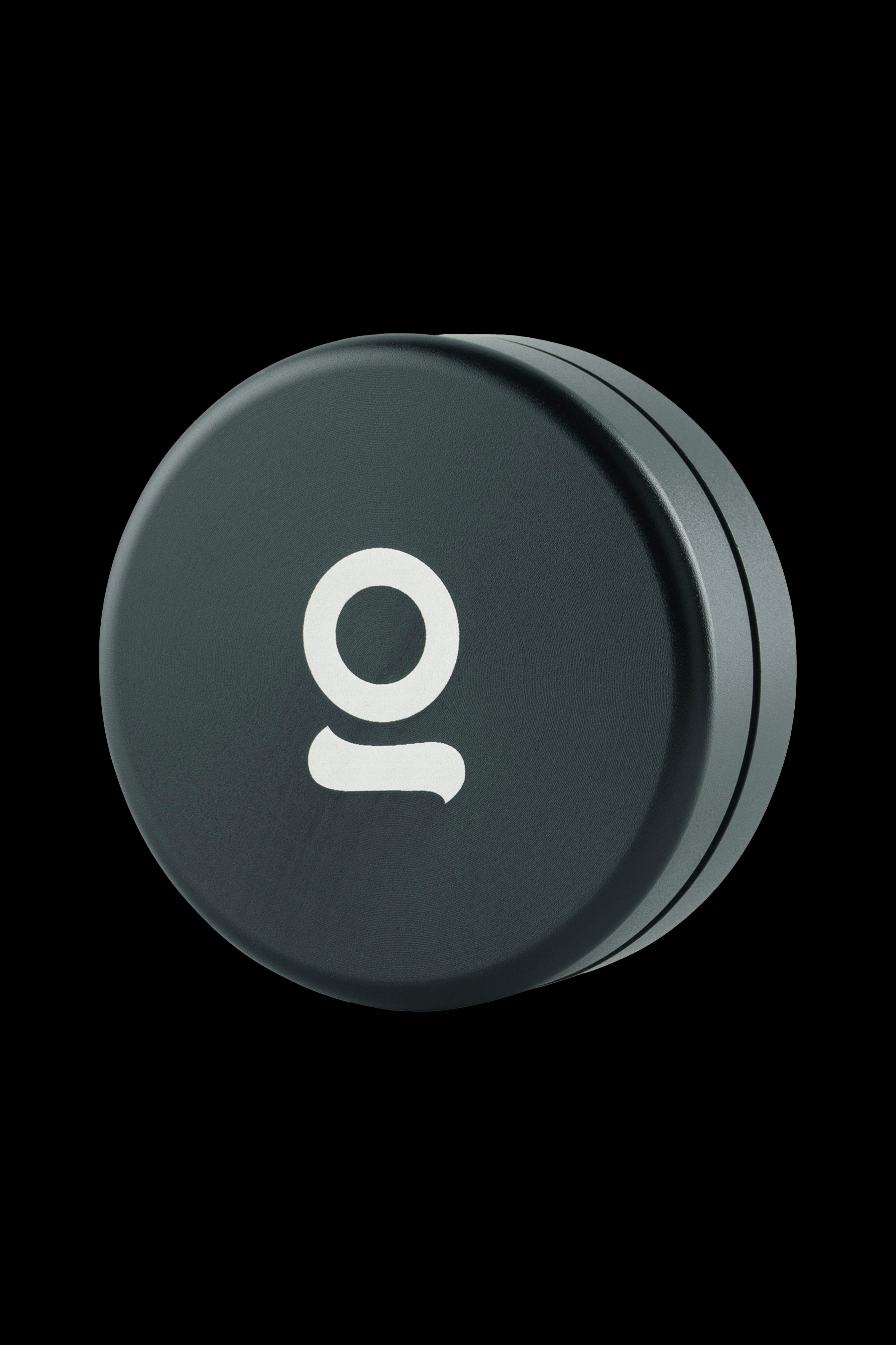 Dark green cannabis storage container with white “o” logo.