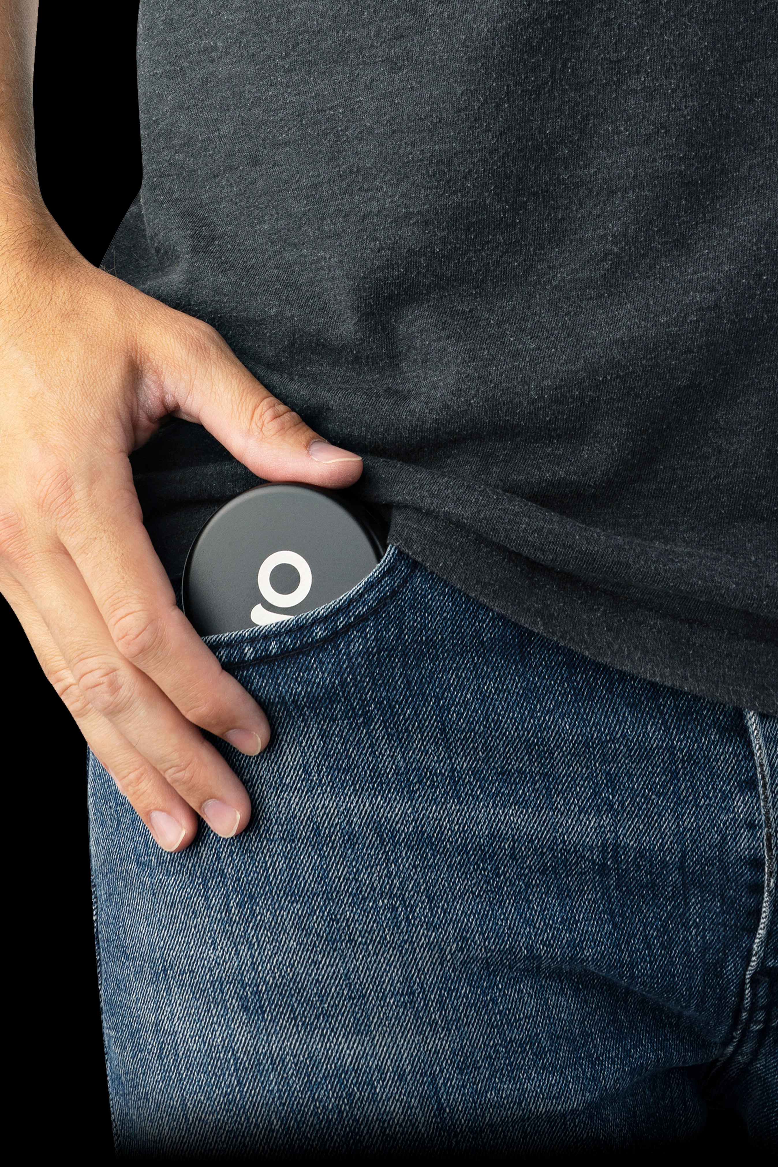 Hand reaching into a pocket, revealing a sleek, black cannabis storage container with a white “9” logo.