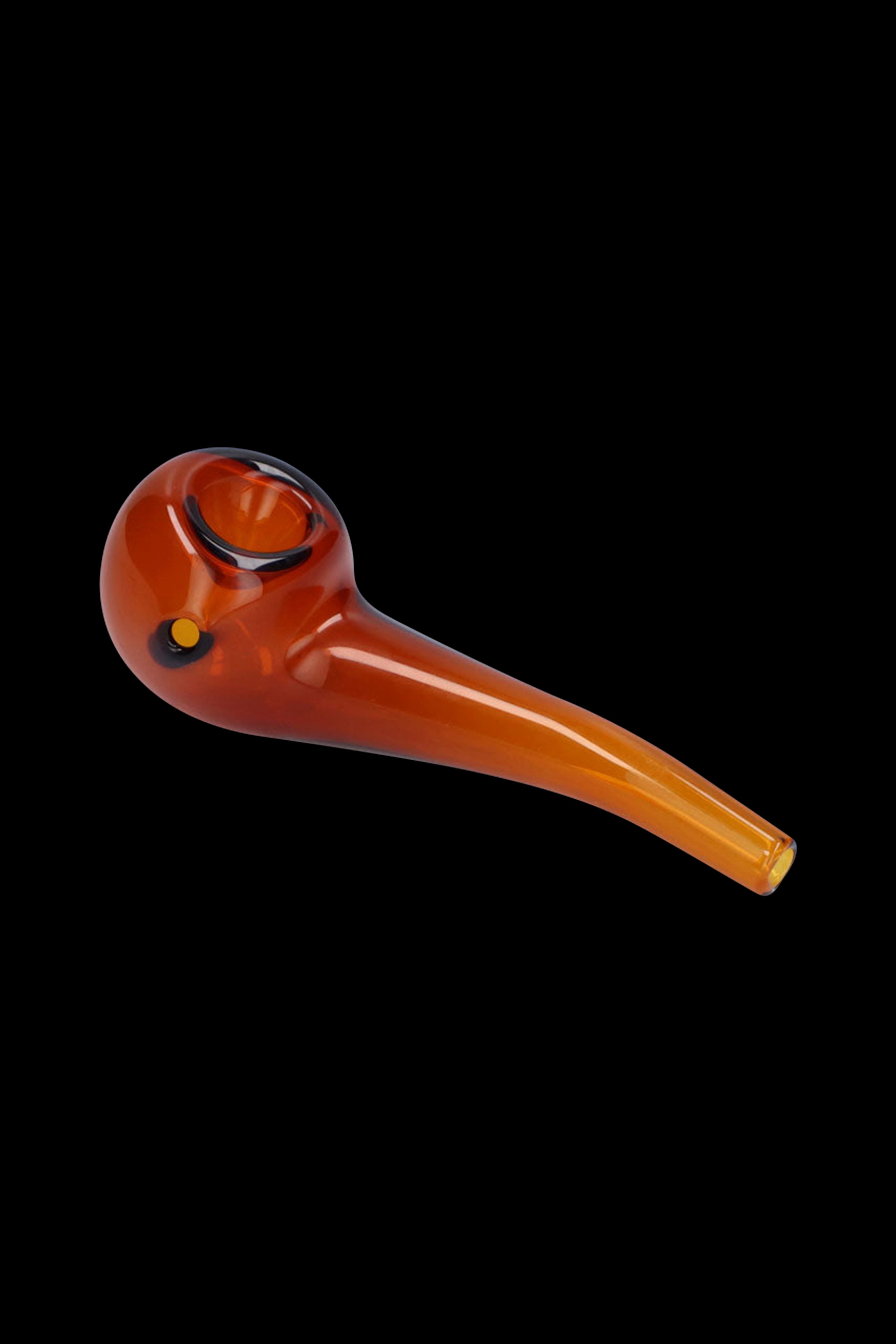 Amber glass smoking pipe on a black background.