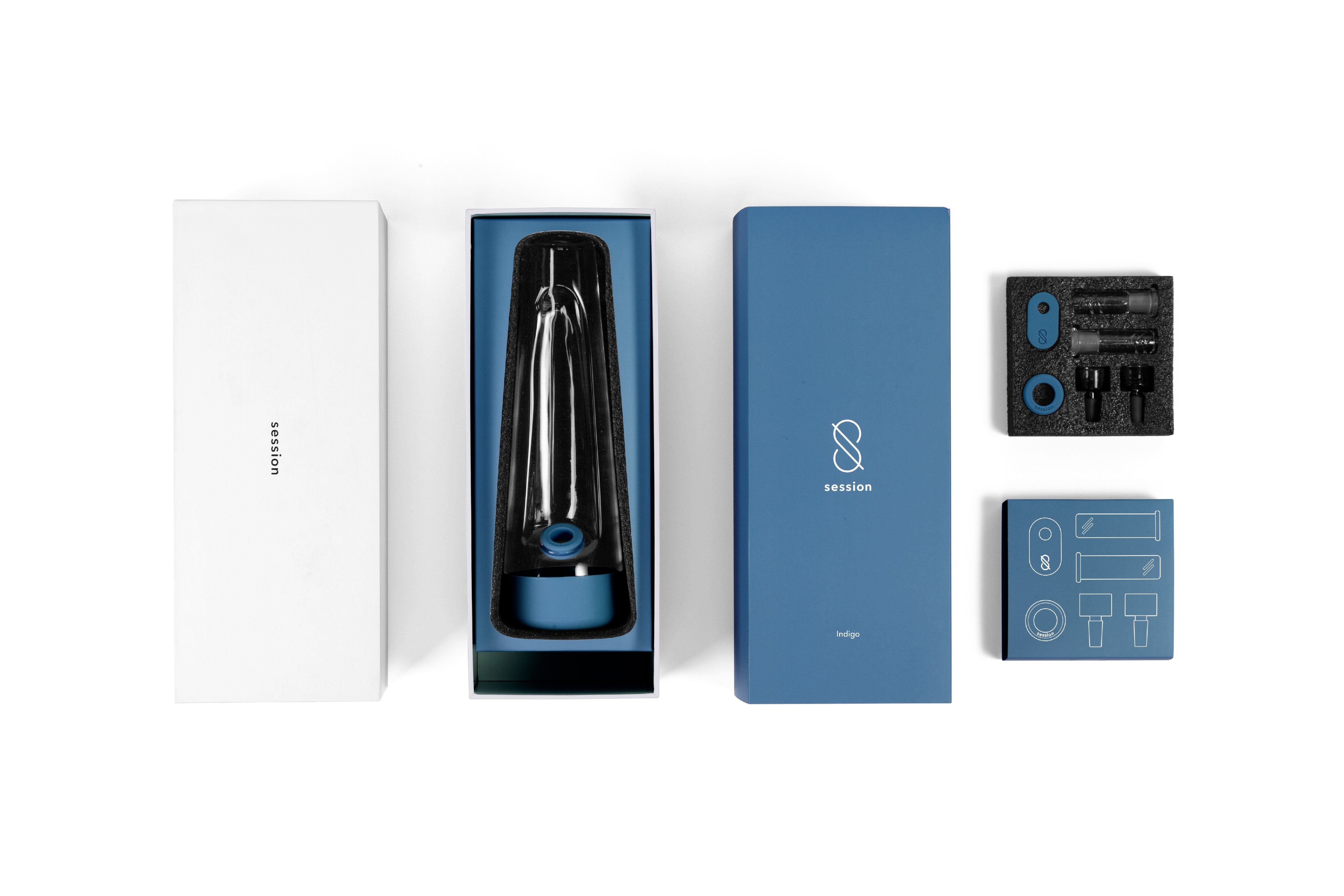 Overhead view of the Session Goods Modern Bong and its indigo box and accessories neatly arranged in foam-lined packaging.