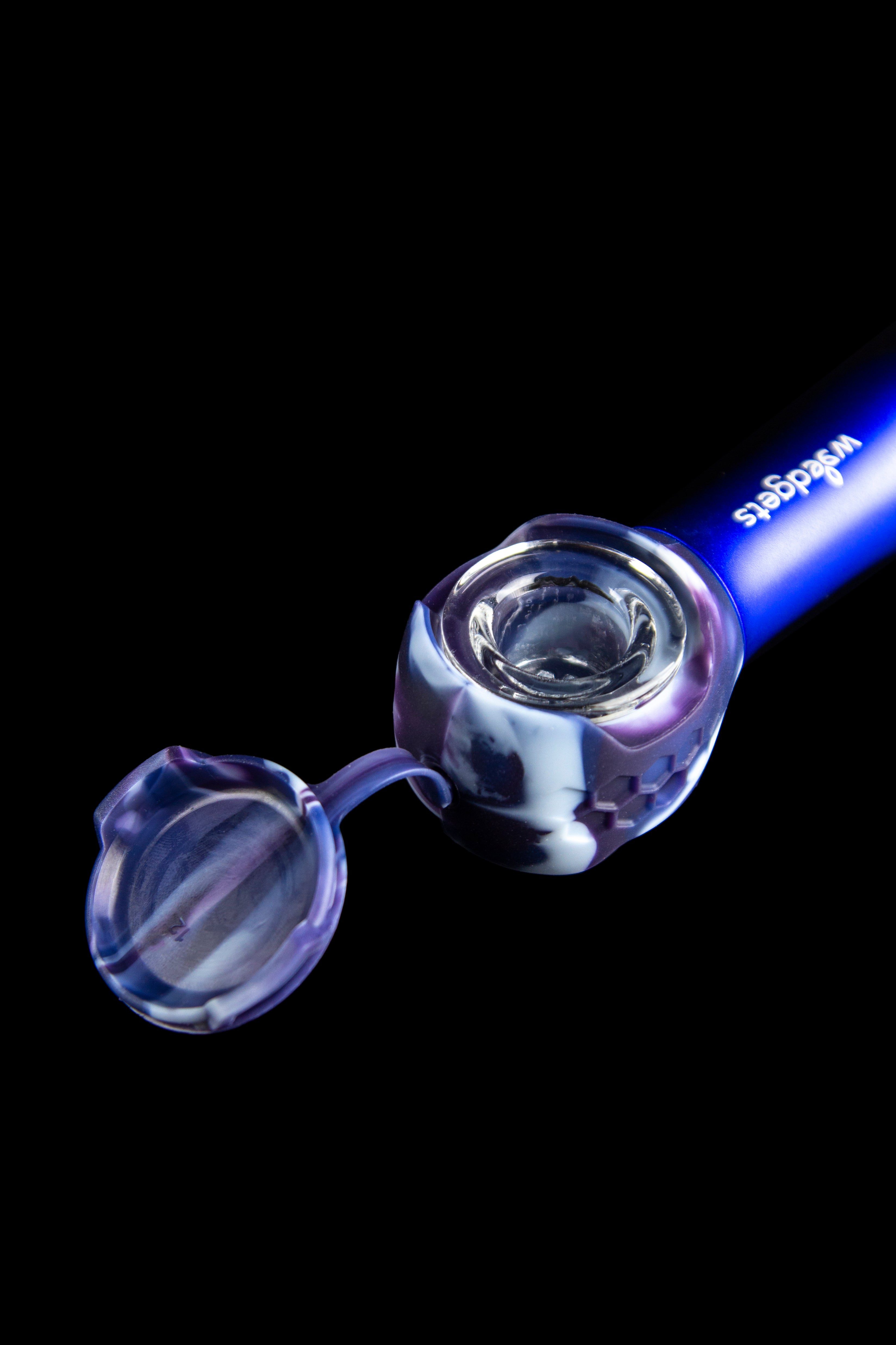 Glass cannabis pipe with iridescent purple and blue swirls, isolated on a black background.